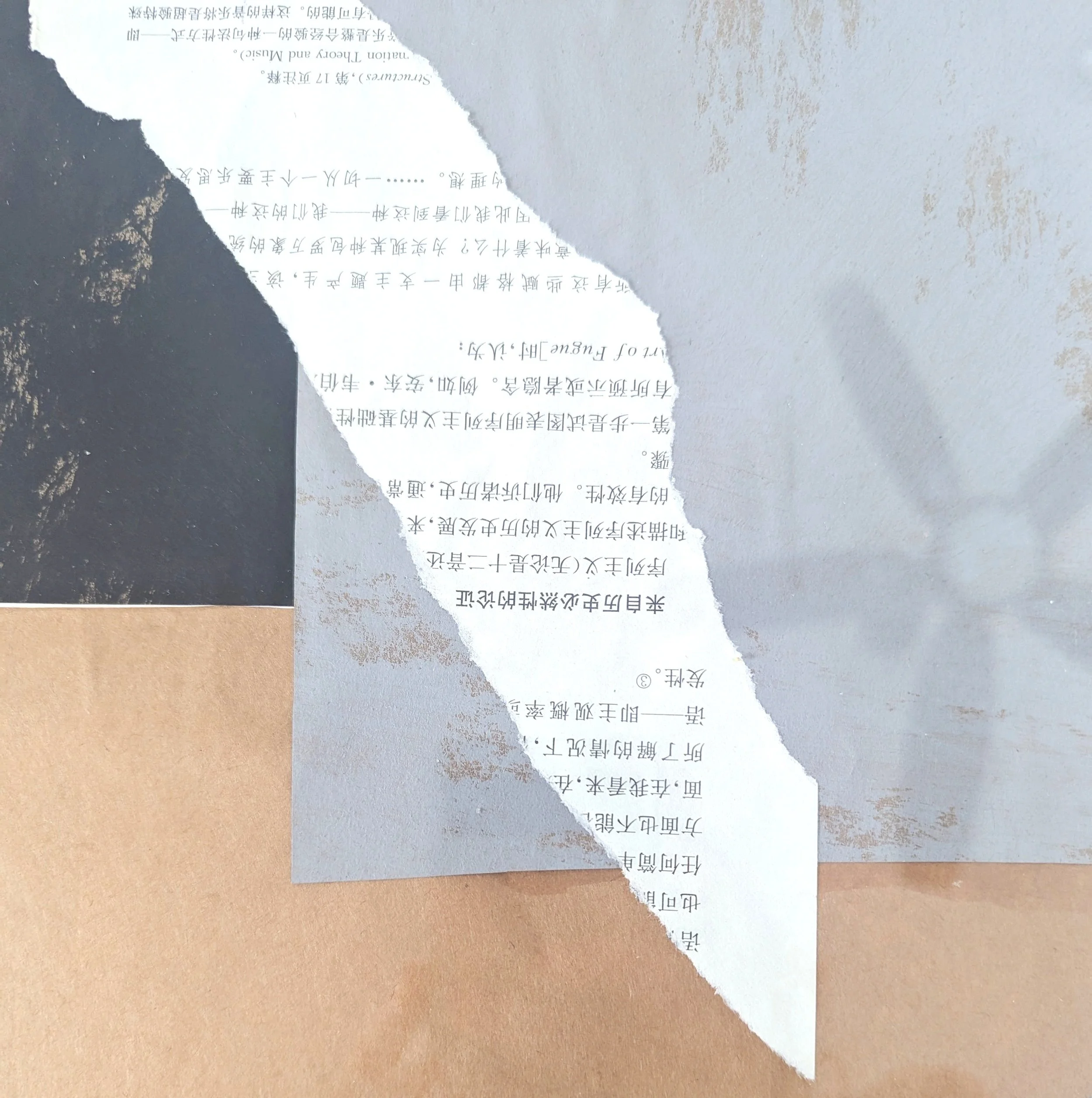 Torn paper revealing handwritten and printed text in Chinese and English on layered paper surfaces.