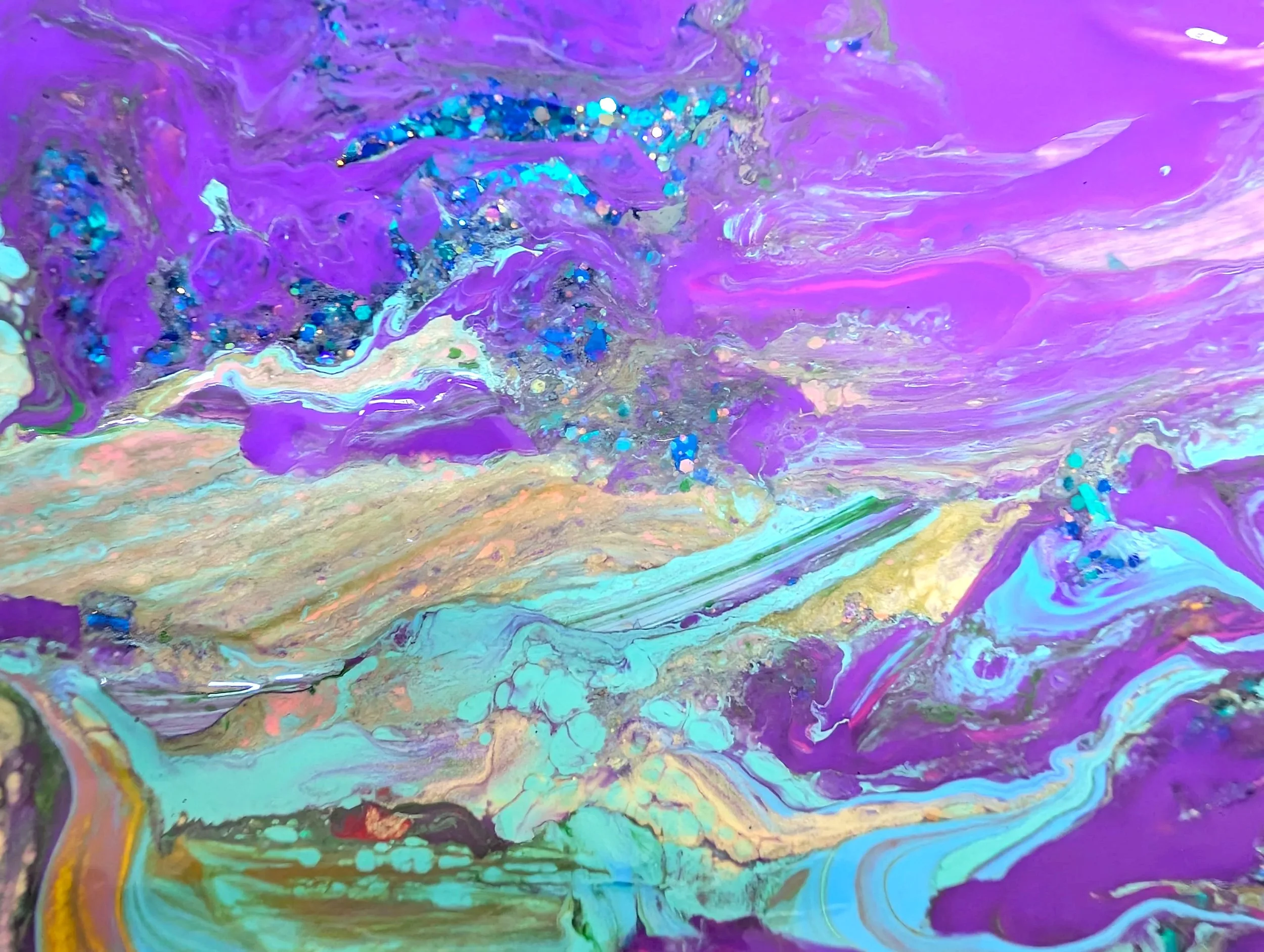 Abstract colorful swirling paint with shades of purple, blue, green, yellow, and white, featuring glitter accents.