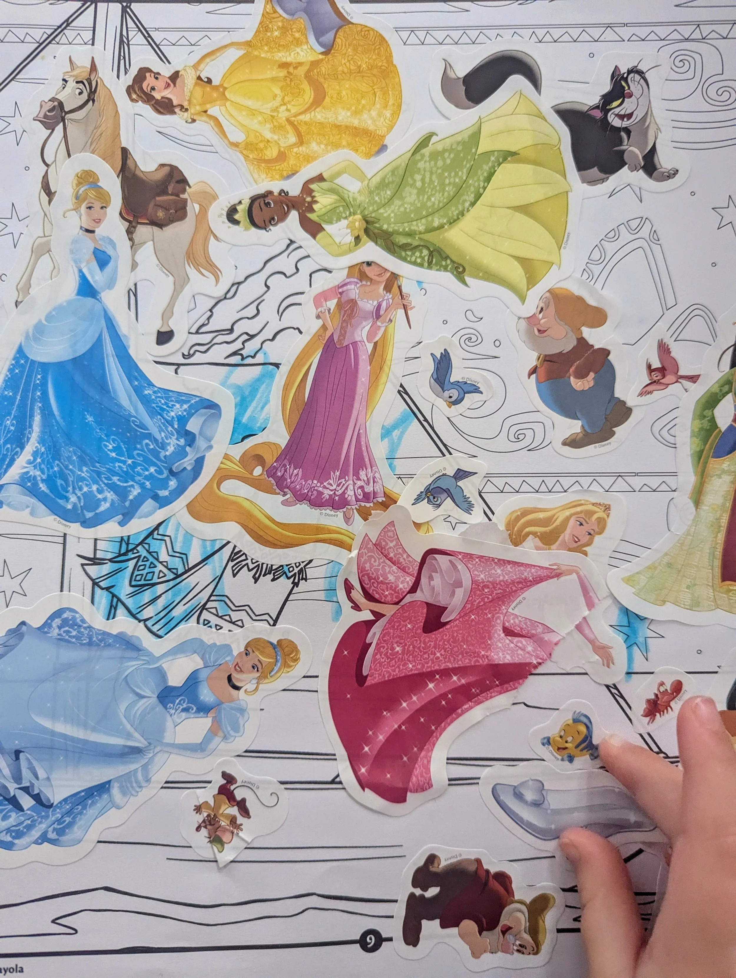 Colorful sticker sheet featuring Disney princesses and characters, including Cinderella, Rapunzel, Aurora, Belle, and others, with some characters partially removed.