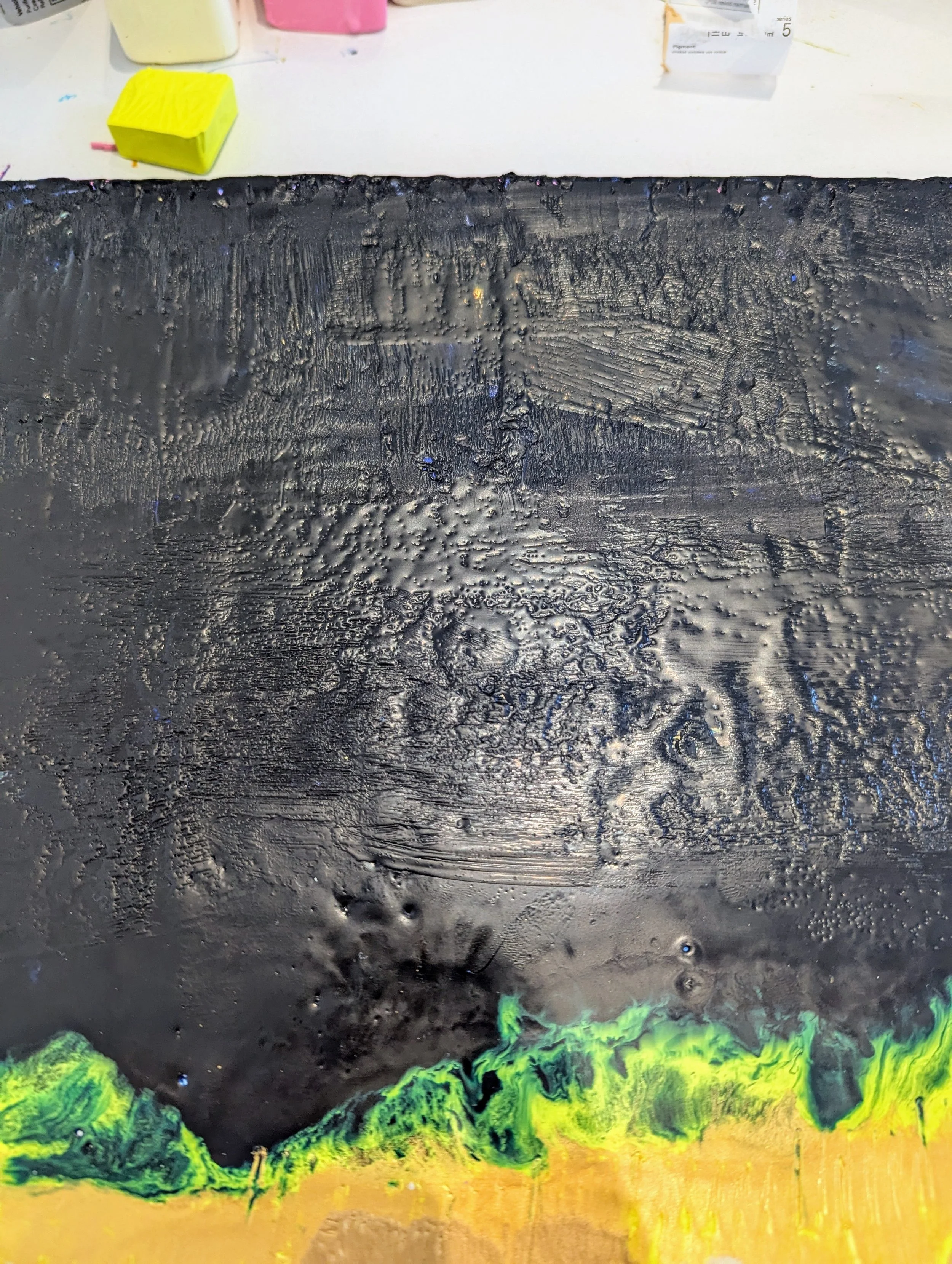 Abstract painting with black background, green and yellow accents at the bottom, textured surface showing brush strokes and paint details.