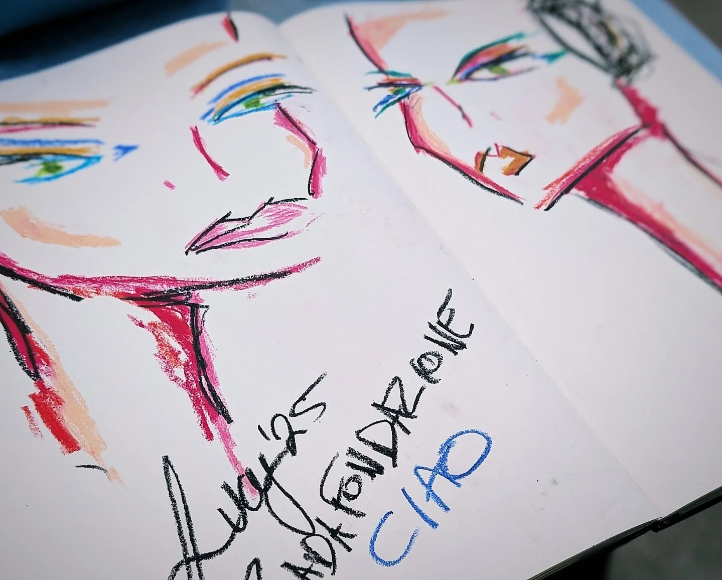 A colorful hand-drawn illustration of two faces with closed eyes, and the phrase "Just Because" handwritten below in black and blue ink.
