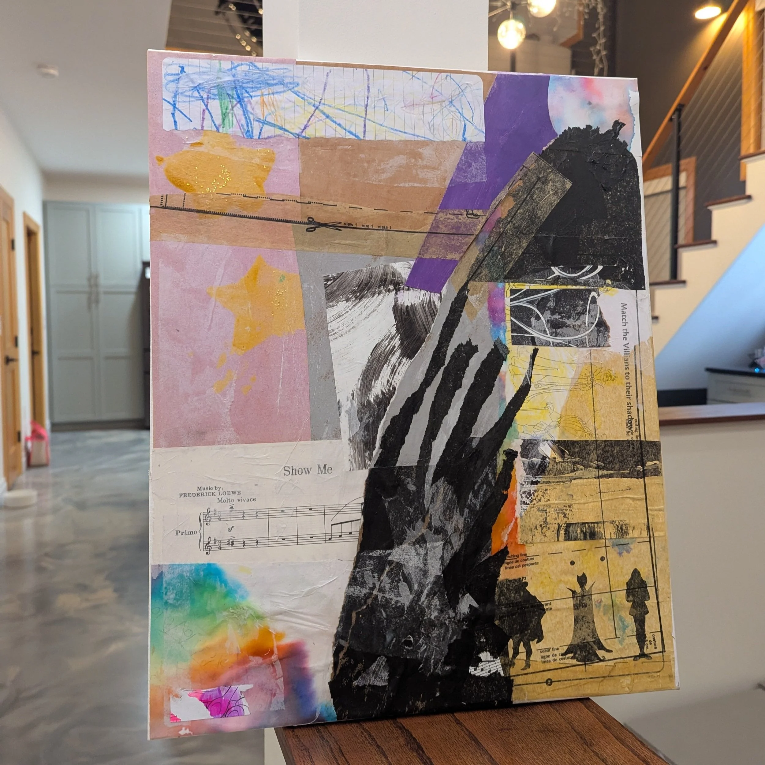 Collage artwork combining abstract shapes, children's drawings, sheet music, and black-and-white printed images.