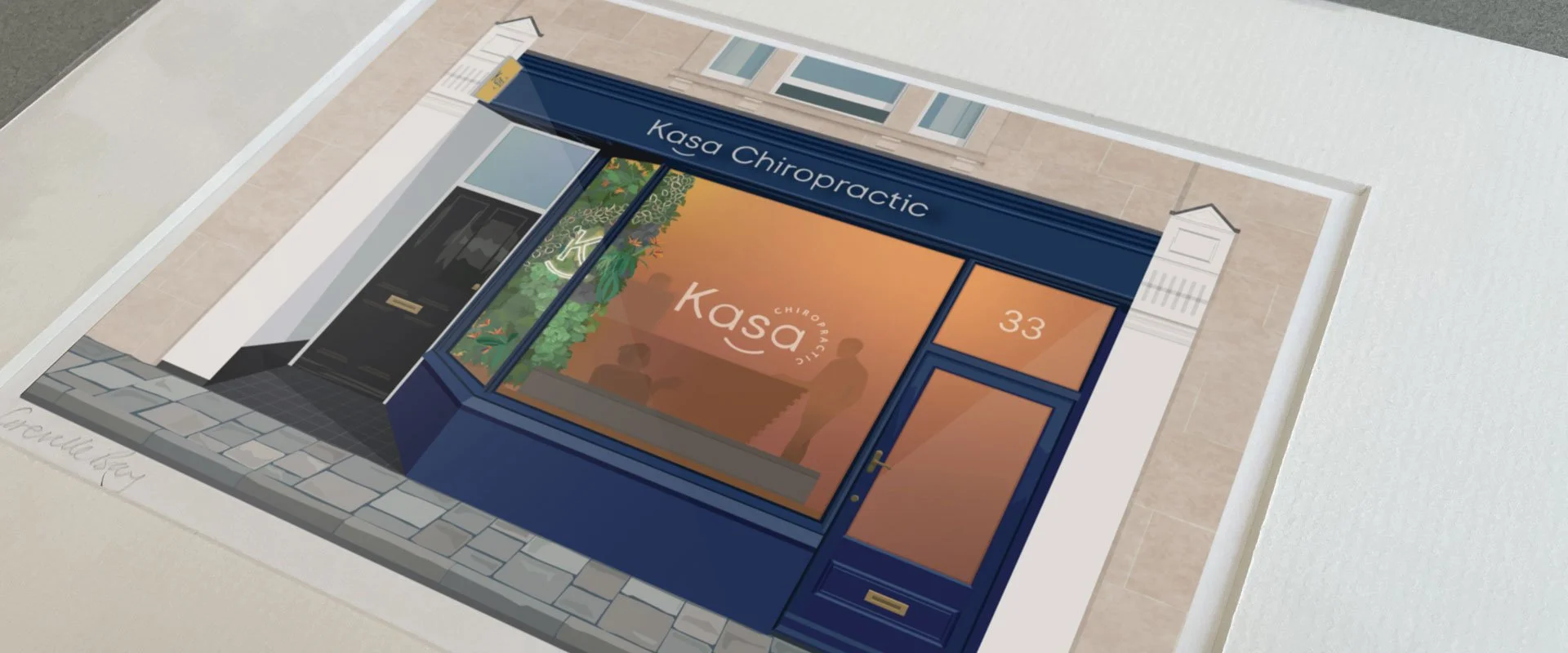 An image showing a print of my illustration of the shop front of Kasa Chiropractic. Drawn as a Precious Places project