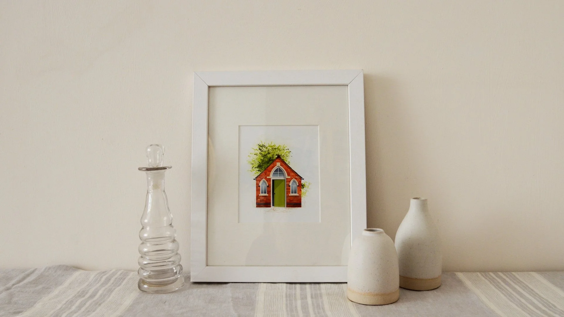 A framed print of the chapel on the shelf at home