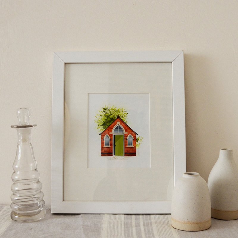 A framed picture of the chapel on the shelf at home