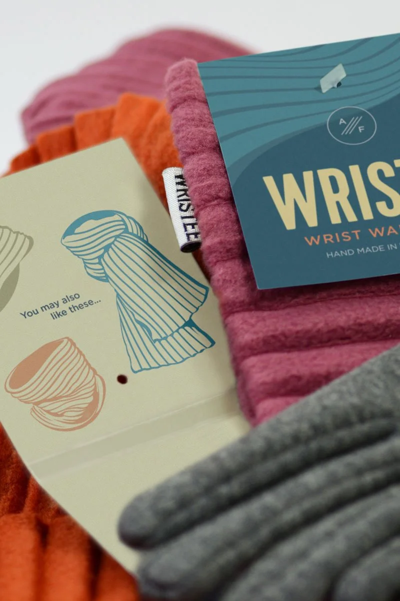 A photo of the new label design on some products - gloves, wristees and a scarf
