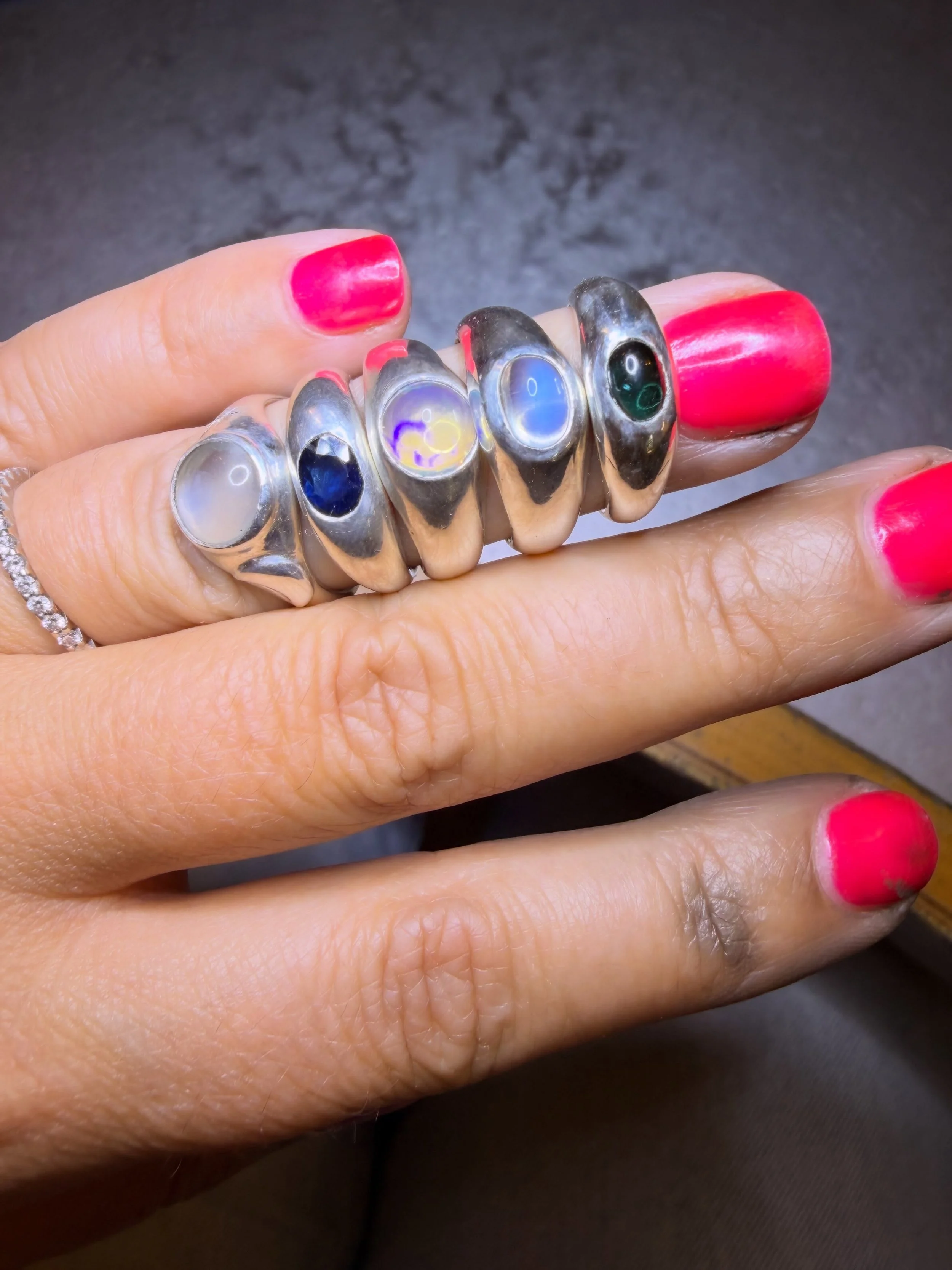There are worse ways to spend an afternoon than polishing rings and playing with colours on the bench.

A little lineup of gemmy things currently keeping me company: tourmaline, moonstones, opal and sapphire &mdash; all glowing, shifting and making i