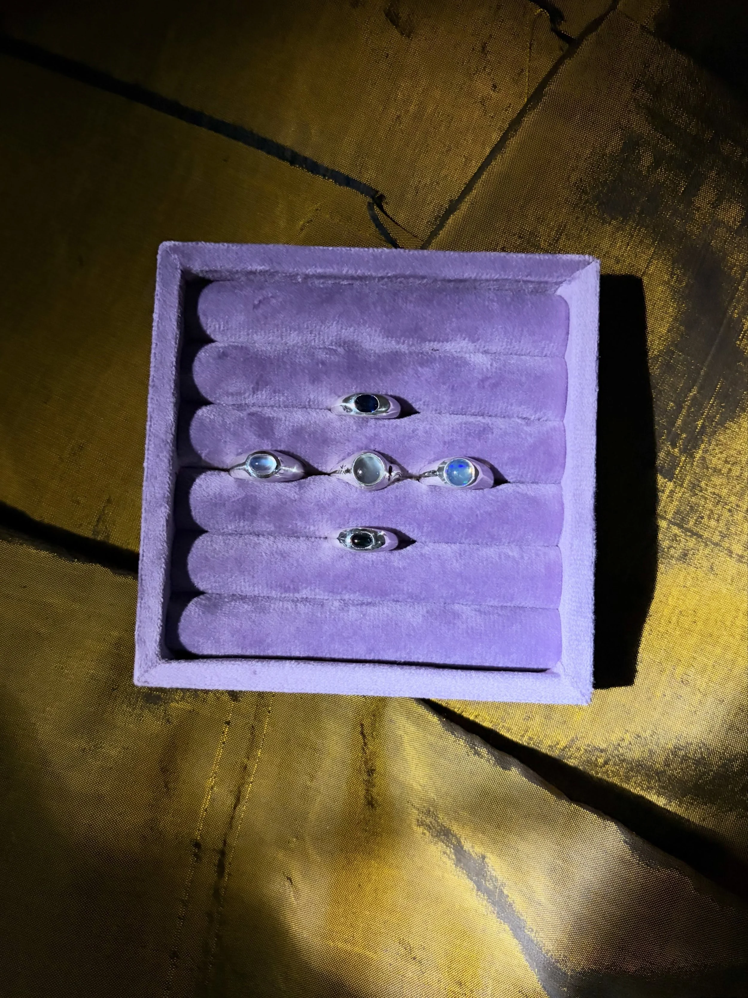Moody Rings 🔮

A collection of moody little silver signets, each set with a stone that seems to have a mind of its own and will look rather mysterious on your hand.

A deep, deep blue sapphire, a hypnotic opal, moonstones made of actual moonbeams an