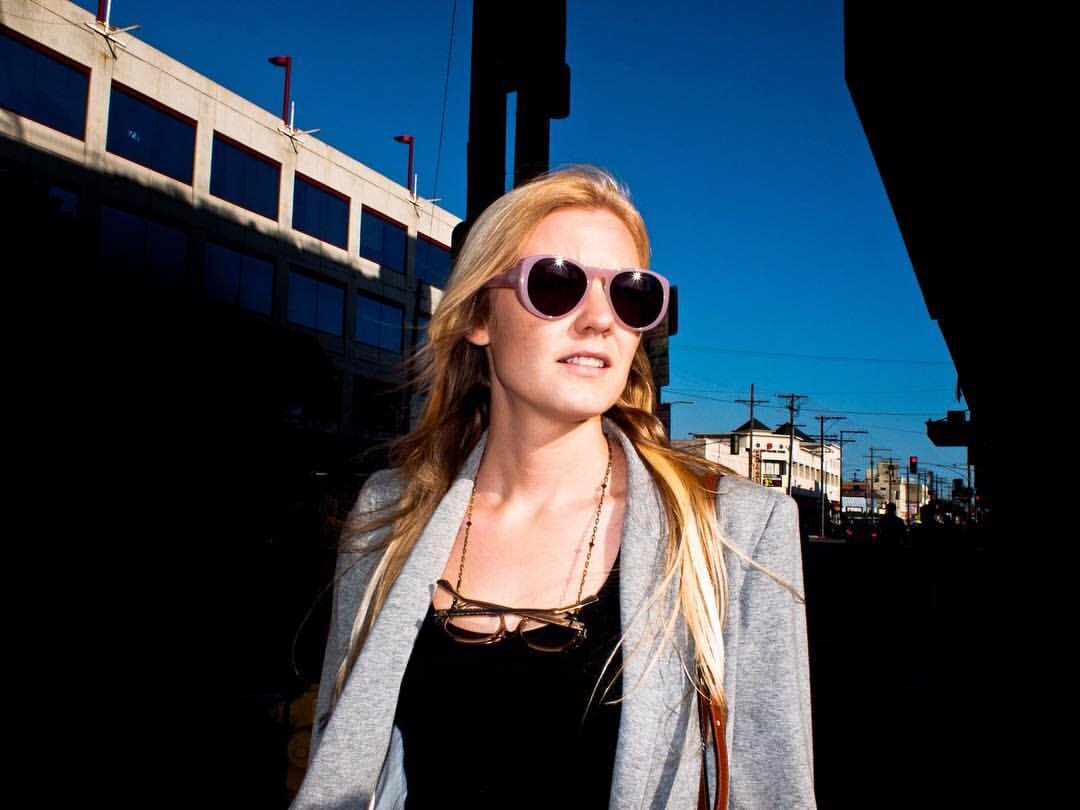 A blonde woman emerging from a corner in downtown of Los Angeles
