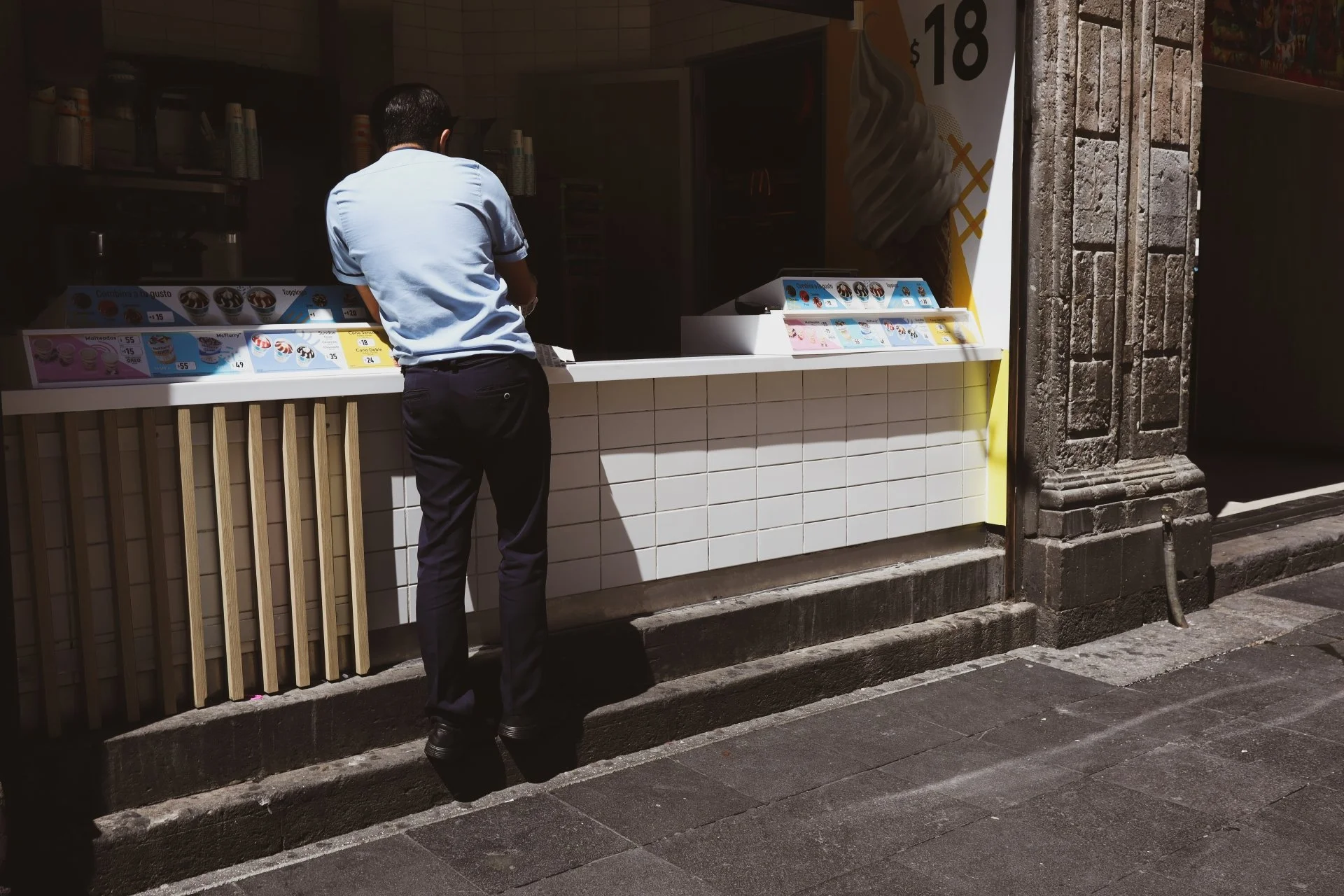 Street photograph of a man at an ice cream shop in Mexico City, Mexico.