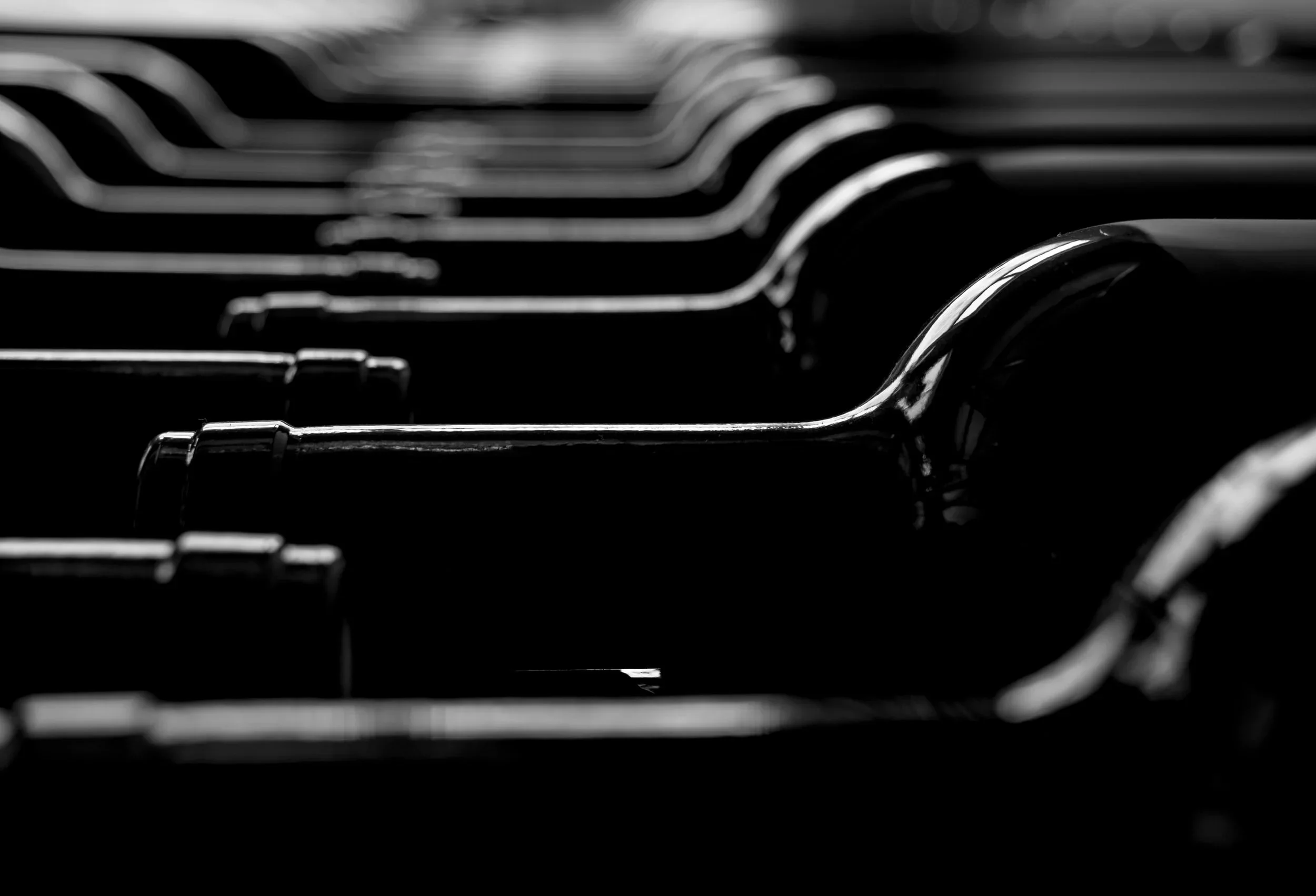 Close-up of black and white photo of wine bottles lined up in a row.