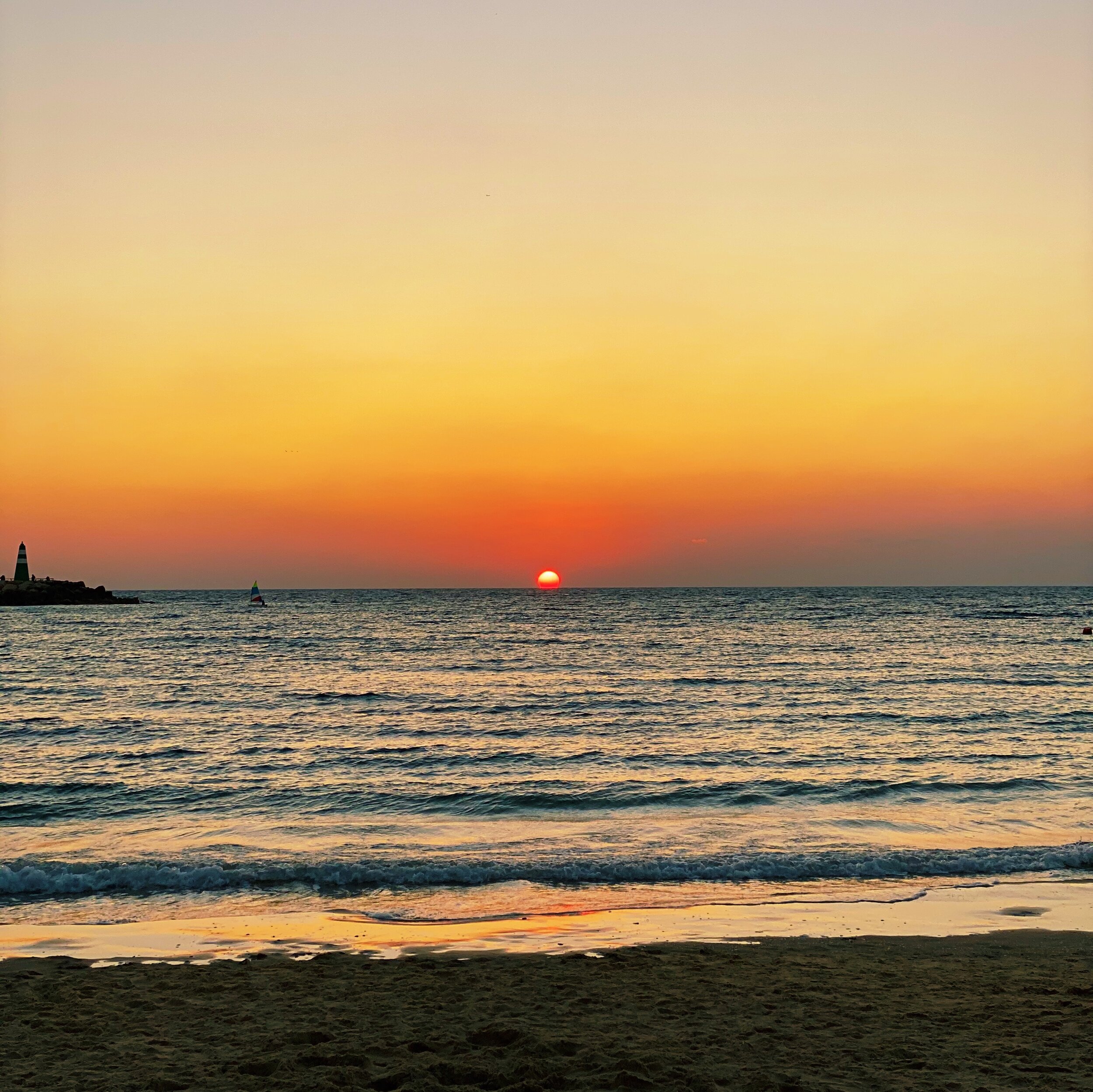 Sun setting along the Mediterranean Sea at Hilton Beach in Tel Aviv