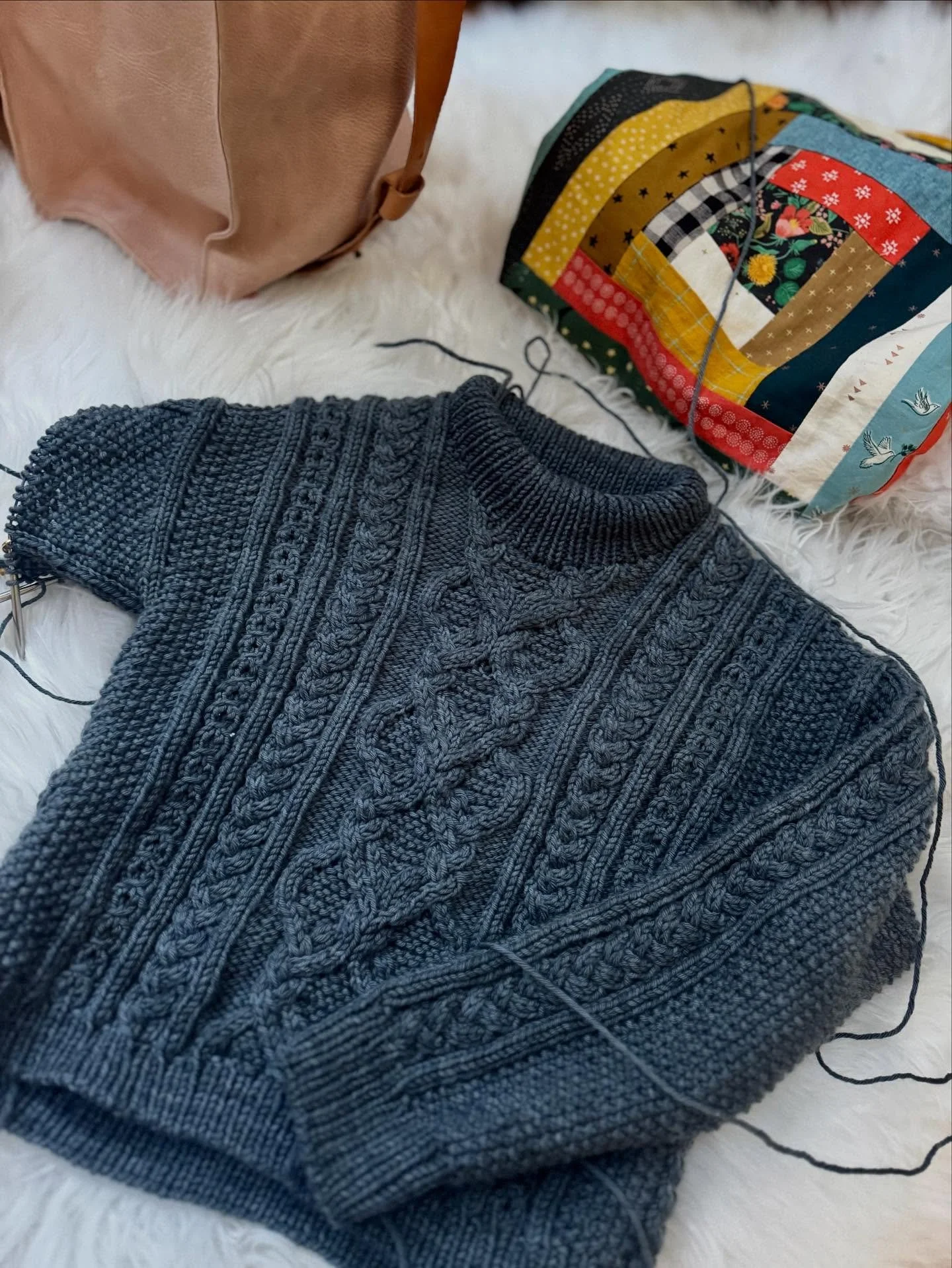 I cast this on in early 2024 and it got slow but steady work on it until it sat abandoned for nearly a year. I picked it back up and have been knitting on it for the past month as I work behind the scenes on a new class for cabling without pain. 

I 