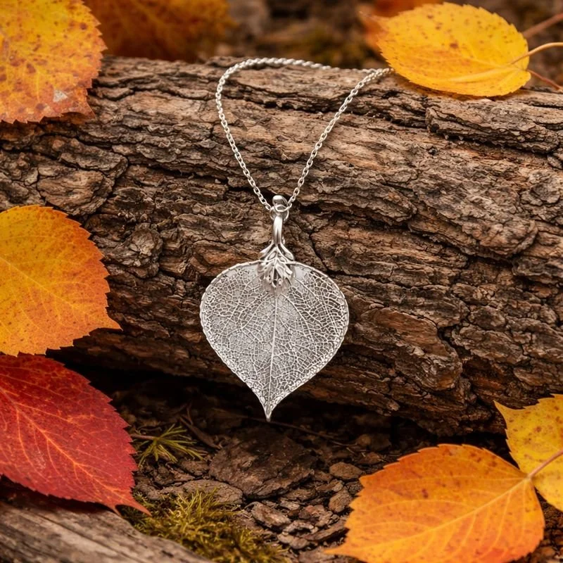 silver necklace on log.jpeg