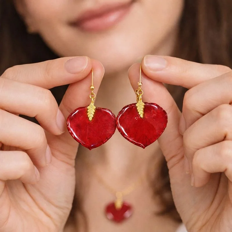 red resin earrings in models fingers.jpeg
