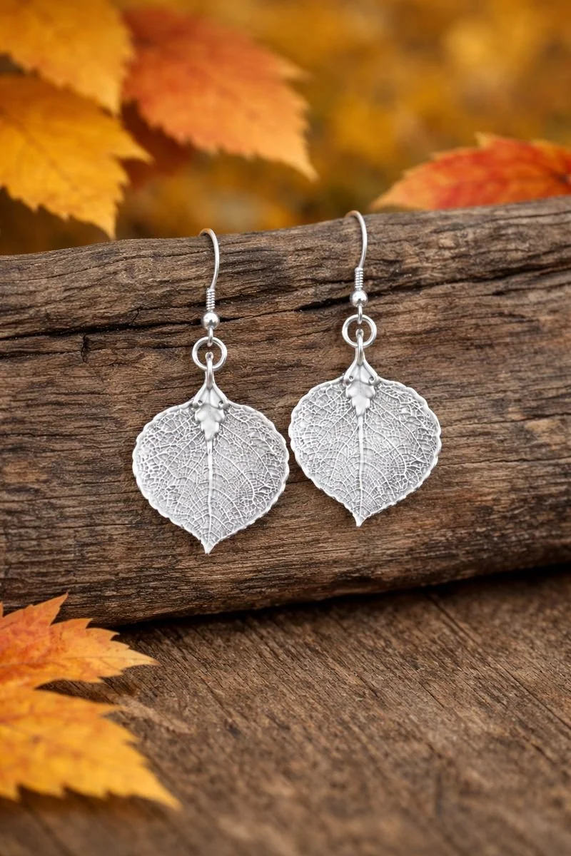 2 silver earrings on log.jpeg