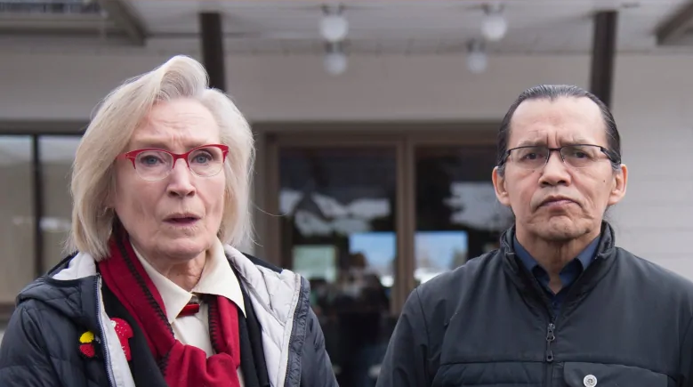 Minister Bennett poses next to wife beater Frank Alec (CBC)