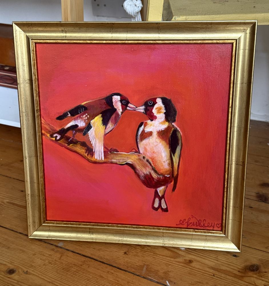 Painting of two birds, possibly woodpeckers, on a branch with a red background, framed in gold.