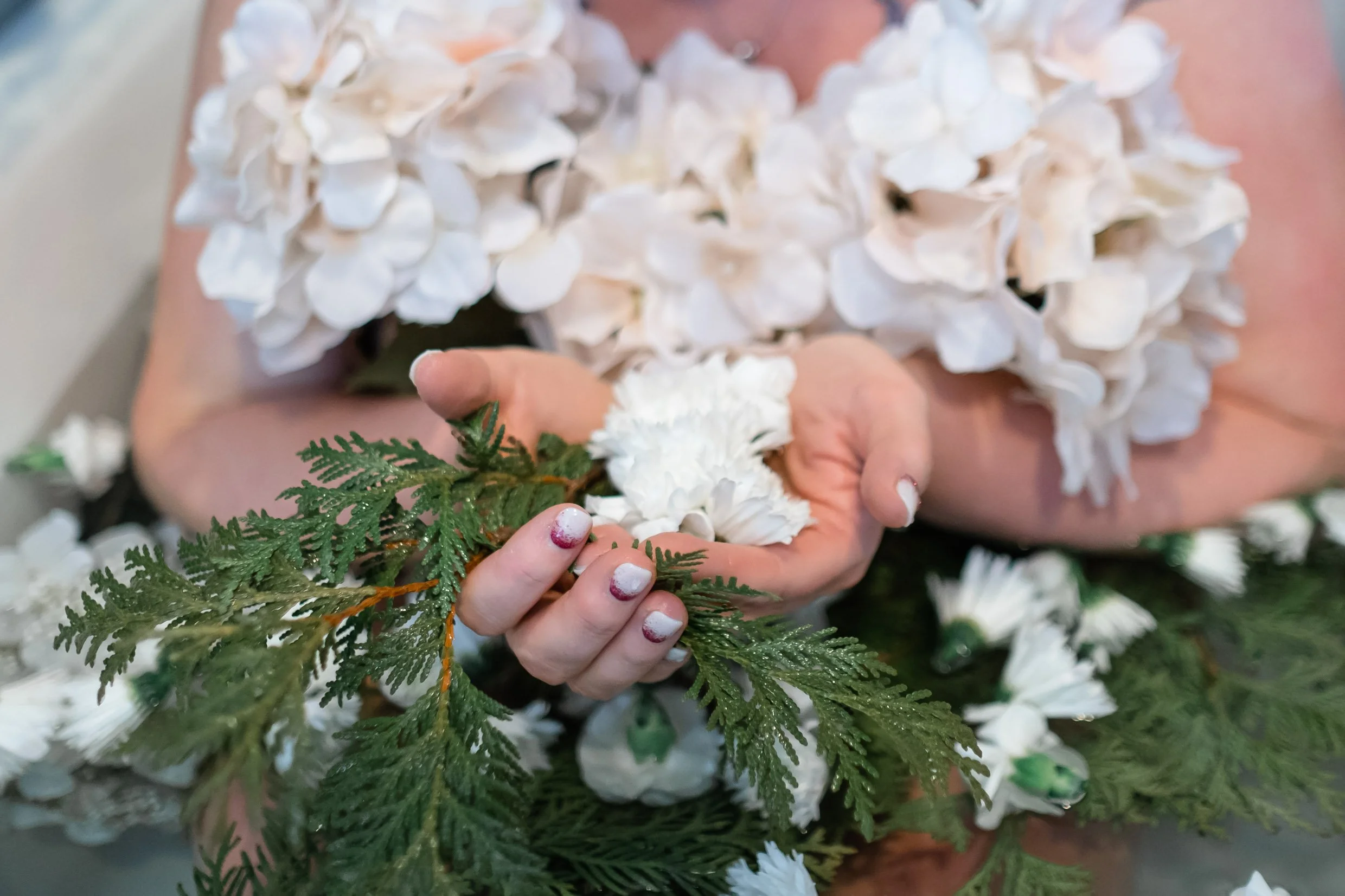 Woman's hands holding herbs for bath