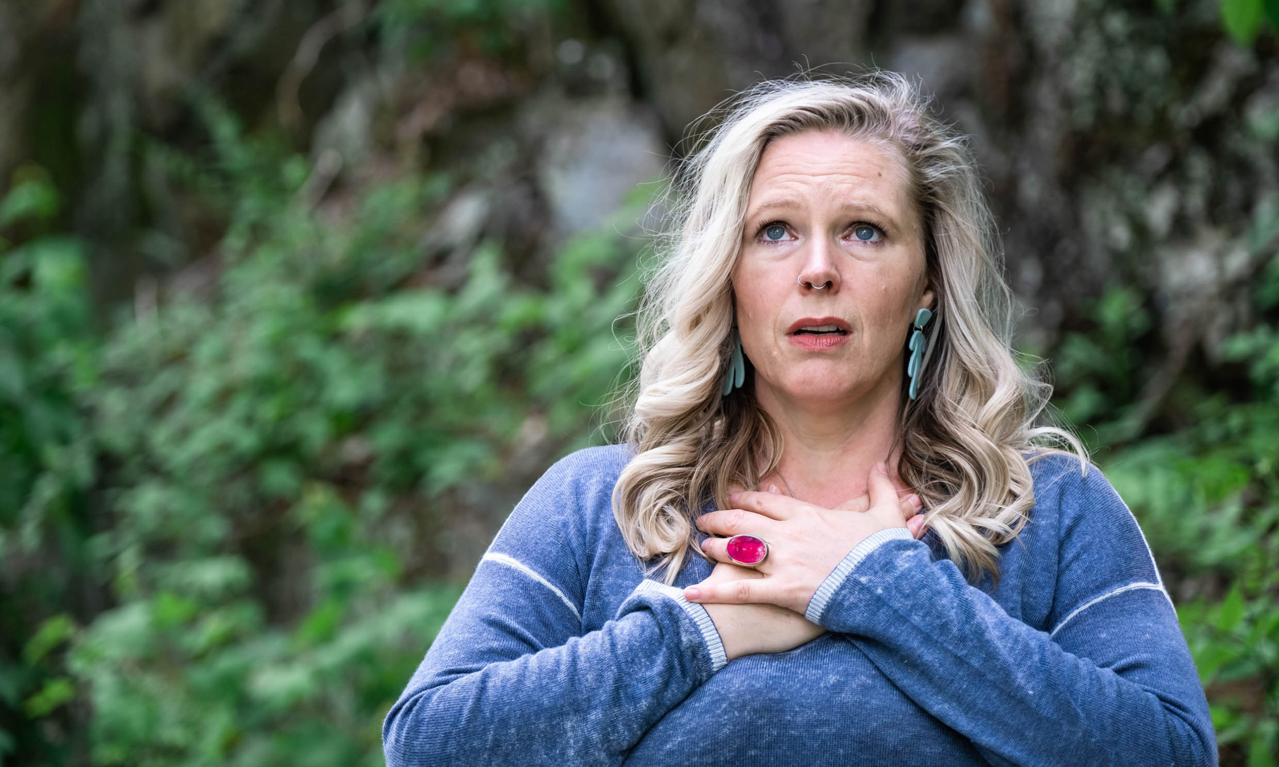 Jessica Seguin holding hands to chest and looking worried.png