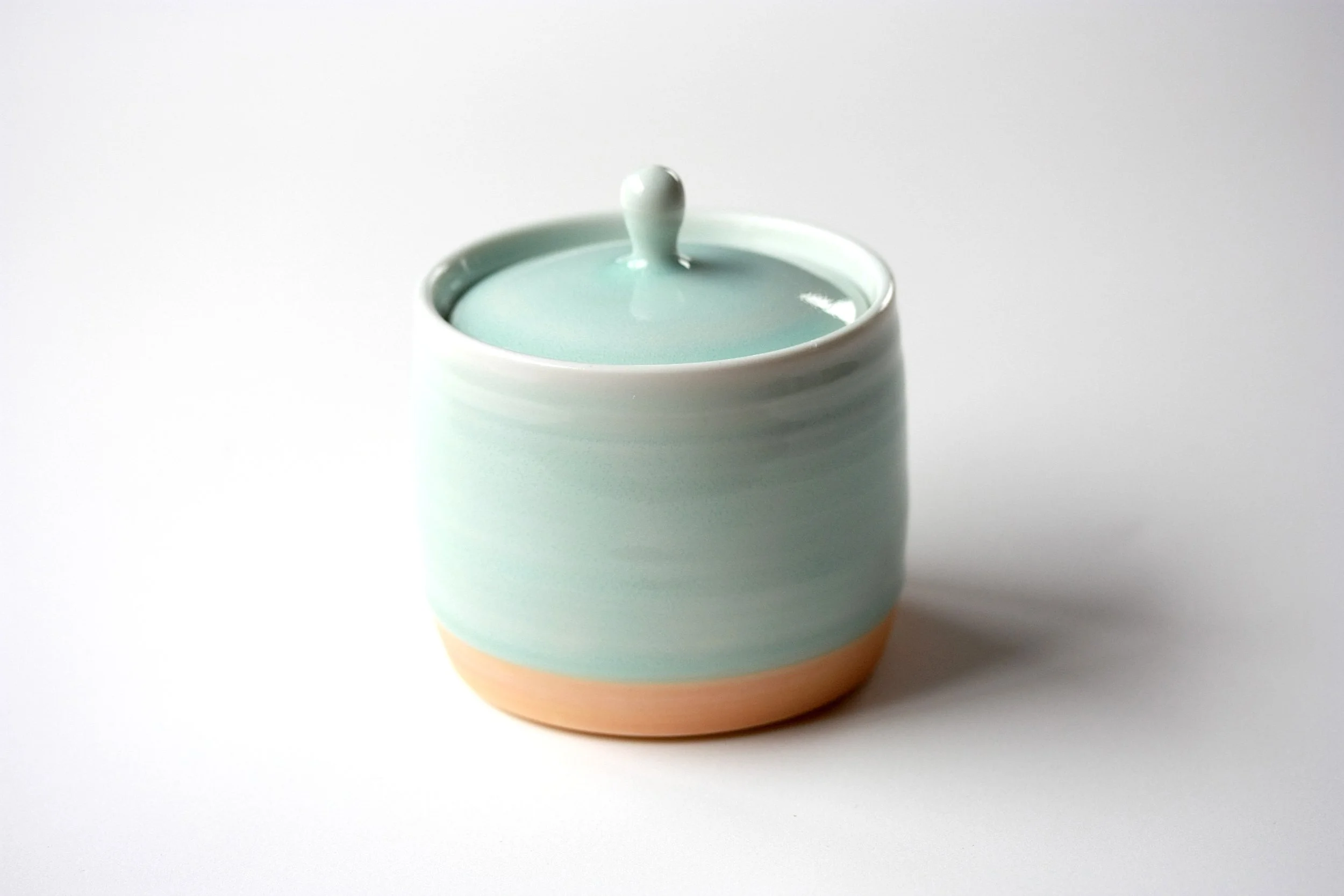 Porcelain lidded jar, orange