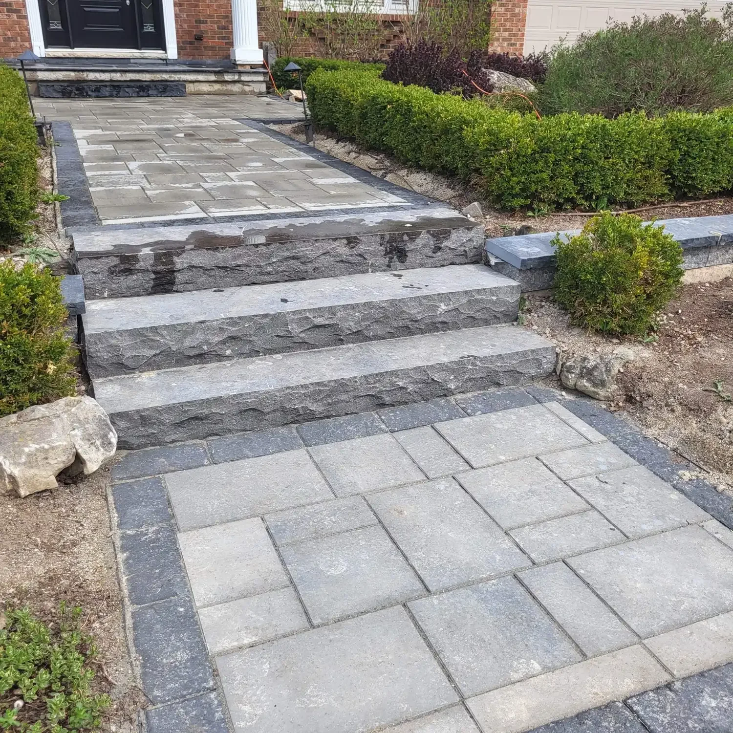 Grey interlock patio, walkway, and stone steps installed by Brothers Landscaping in Waterloo, Ontario