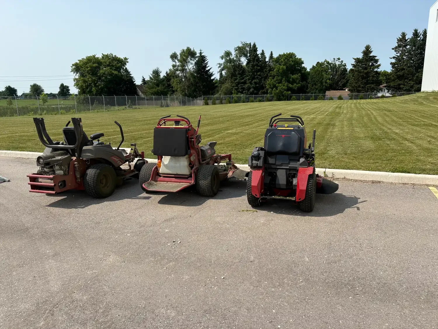 Commercial lawn mowers cutting grass in Elora, Ontario