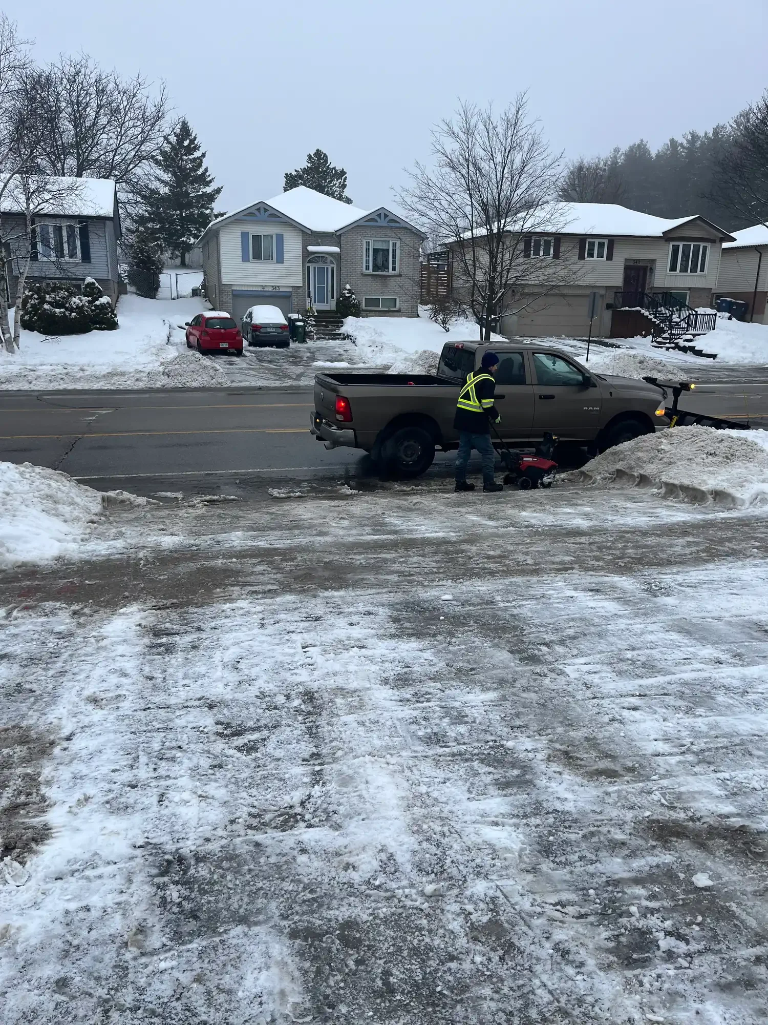 Snowblowing a residential driveway during a Guelph residential snow removal route