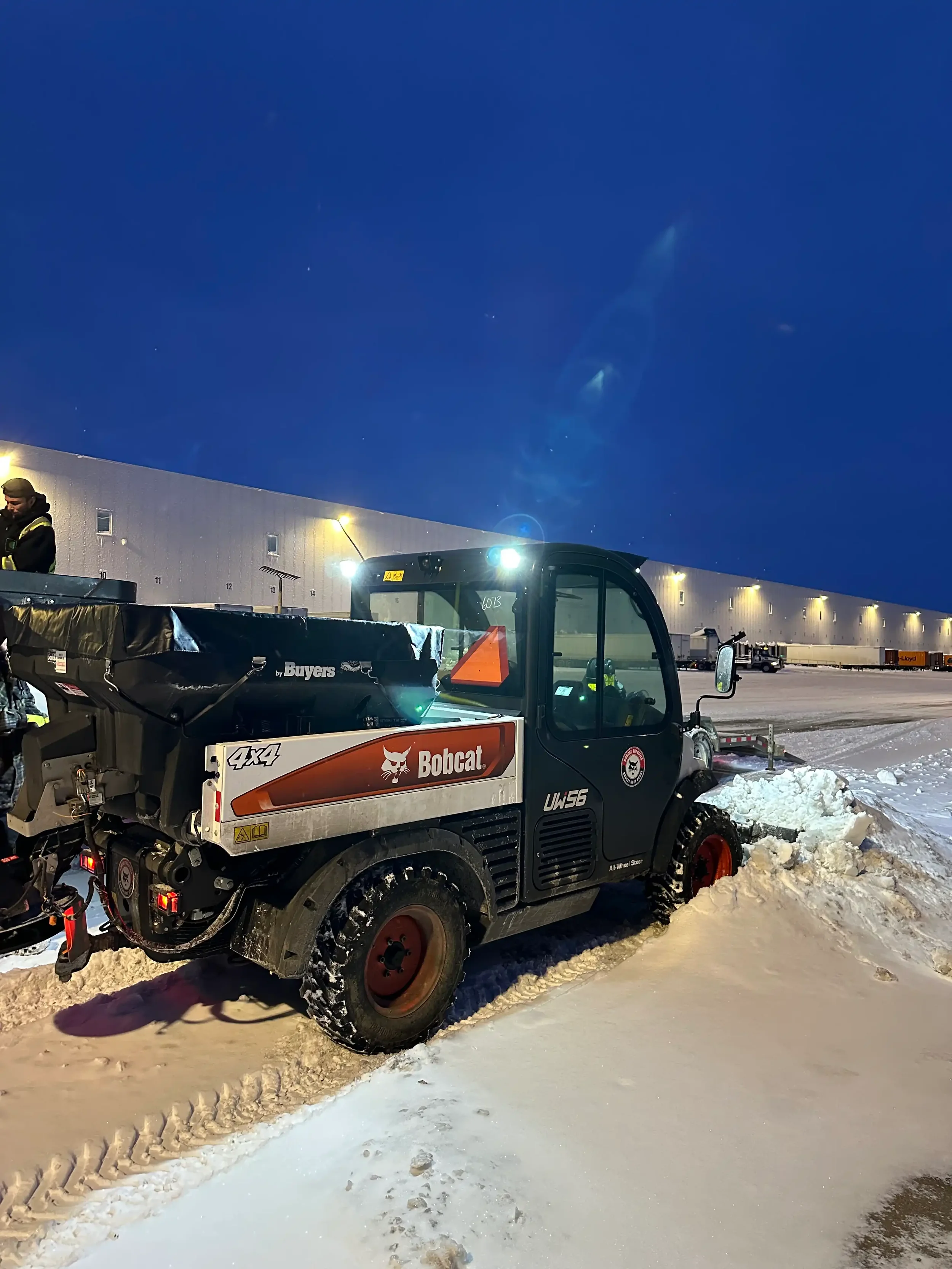Commercial snow removal with a Bobcat Toolcat from Brothers Landscaping