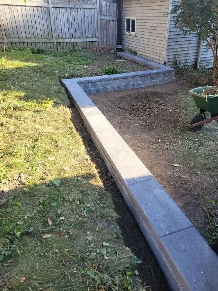 In-ground garden lock retaining wall installed by Brothers Landscaping and Property Maintenance