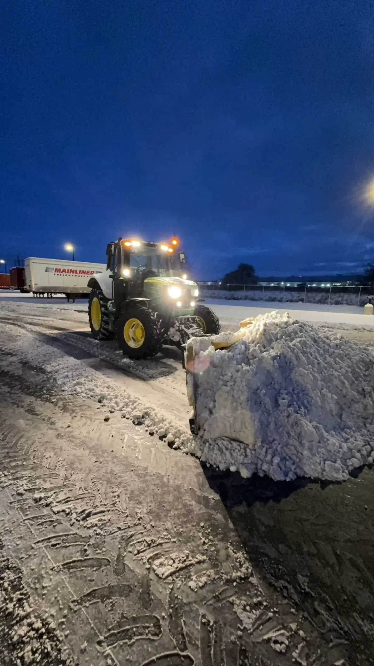 Commercial snow plowing in Elora Ontario with a John Deere tractor