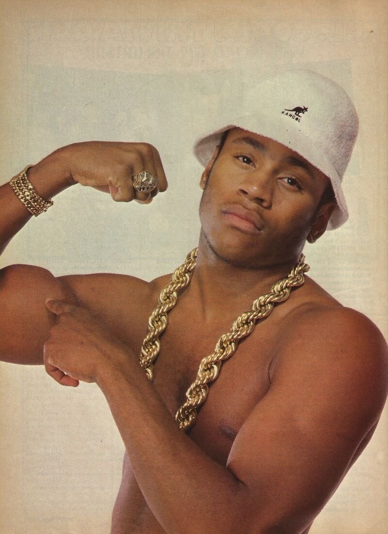 LL Cool J poses in a white Kangol hat and gold chains