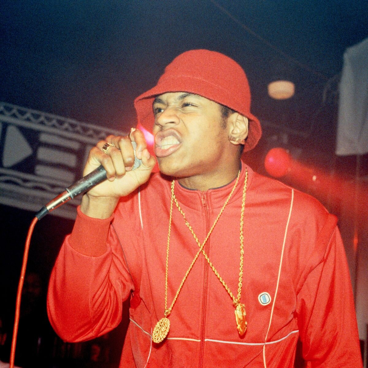 LL Cool J wearing a red tracksuit on stage
