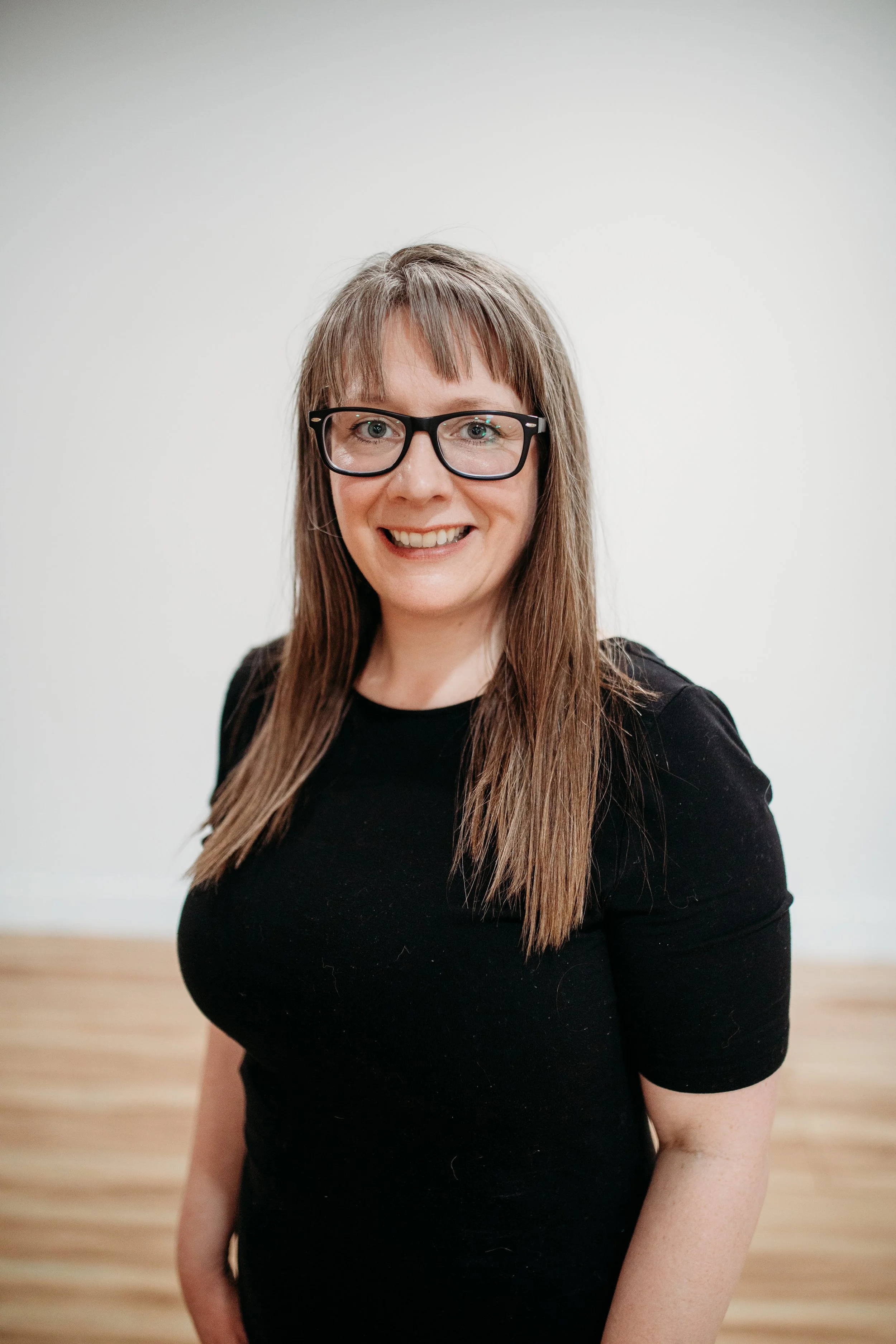 Hilary, owner and instructor of Oasis Yoga Studio in Kuna, Idaho, smiling headshot