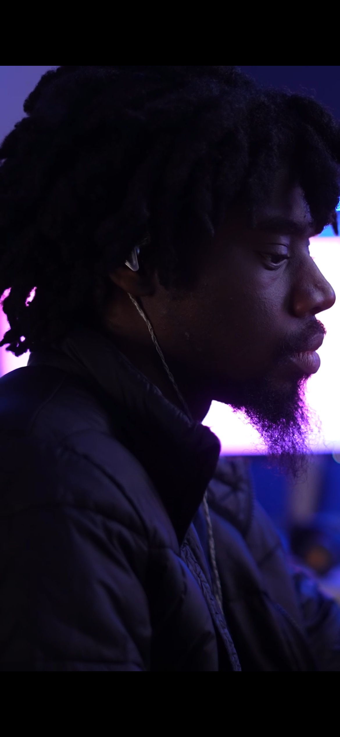 James sitting at production desk.