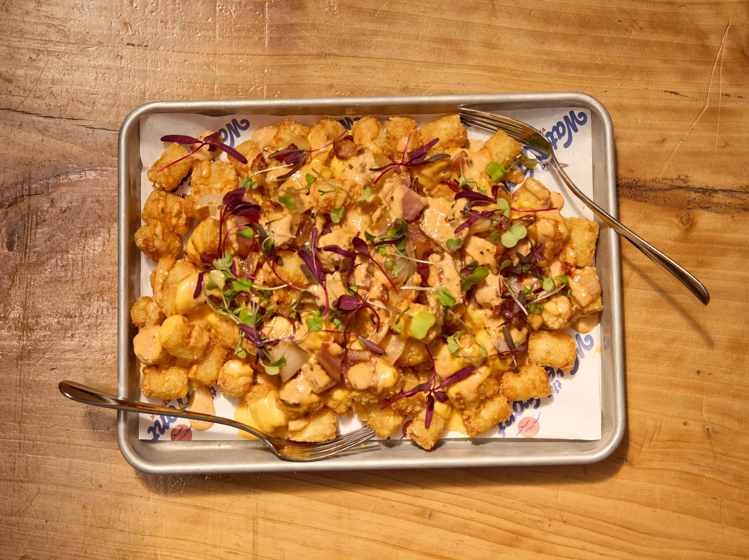 Want something for the table? Try our Loaded Tater Tots with applewood smoked bacon, queso, and grilled onions. 