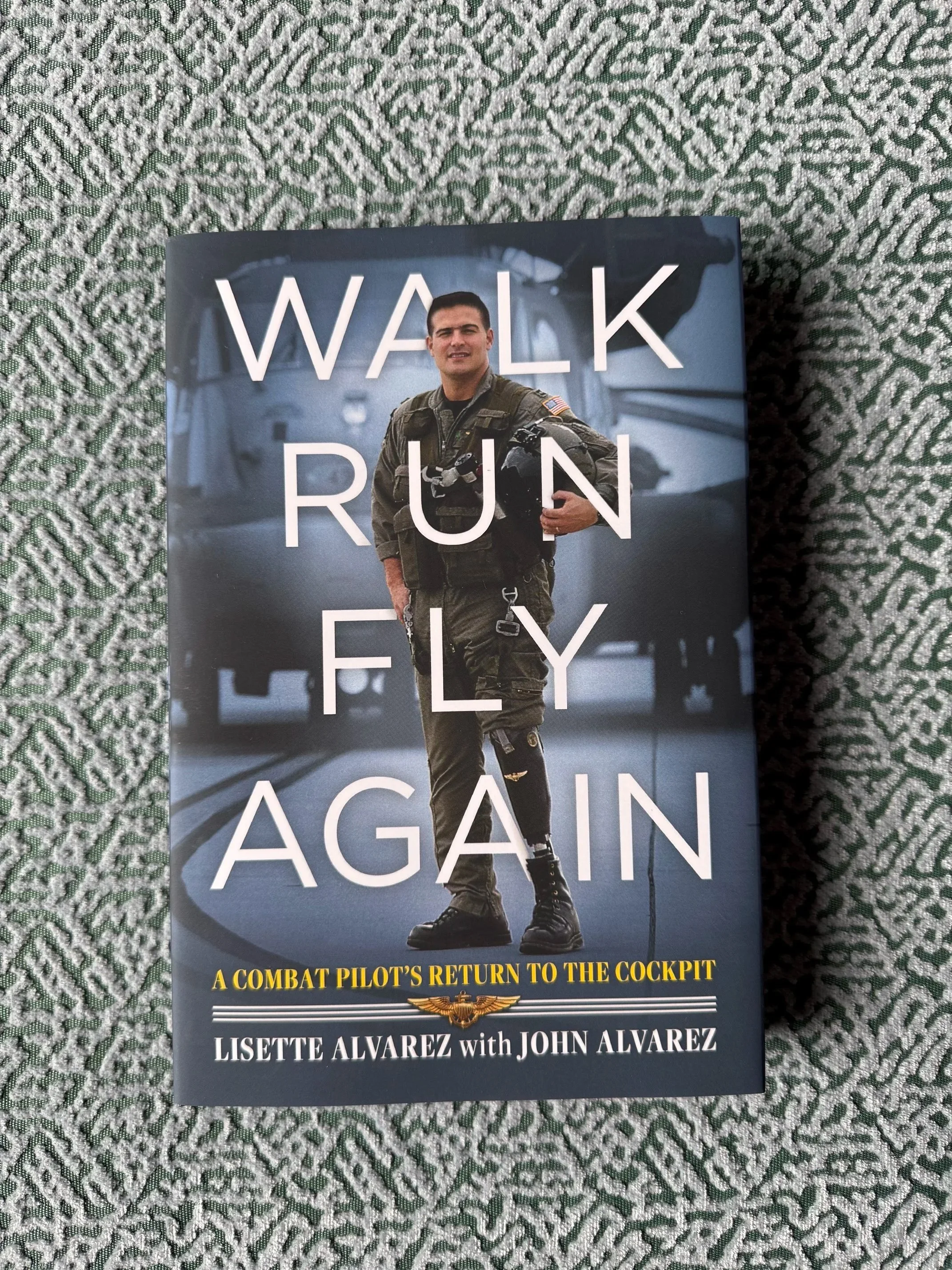 Hard cover with Jacket book cover for Walk, Run, Fly Again, a military memoir featuring John Alvarez, the first U.S. military amputee pilot to return to combat flight.