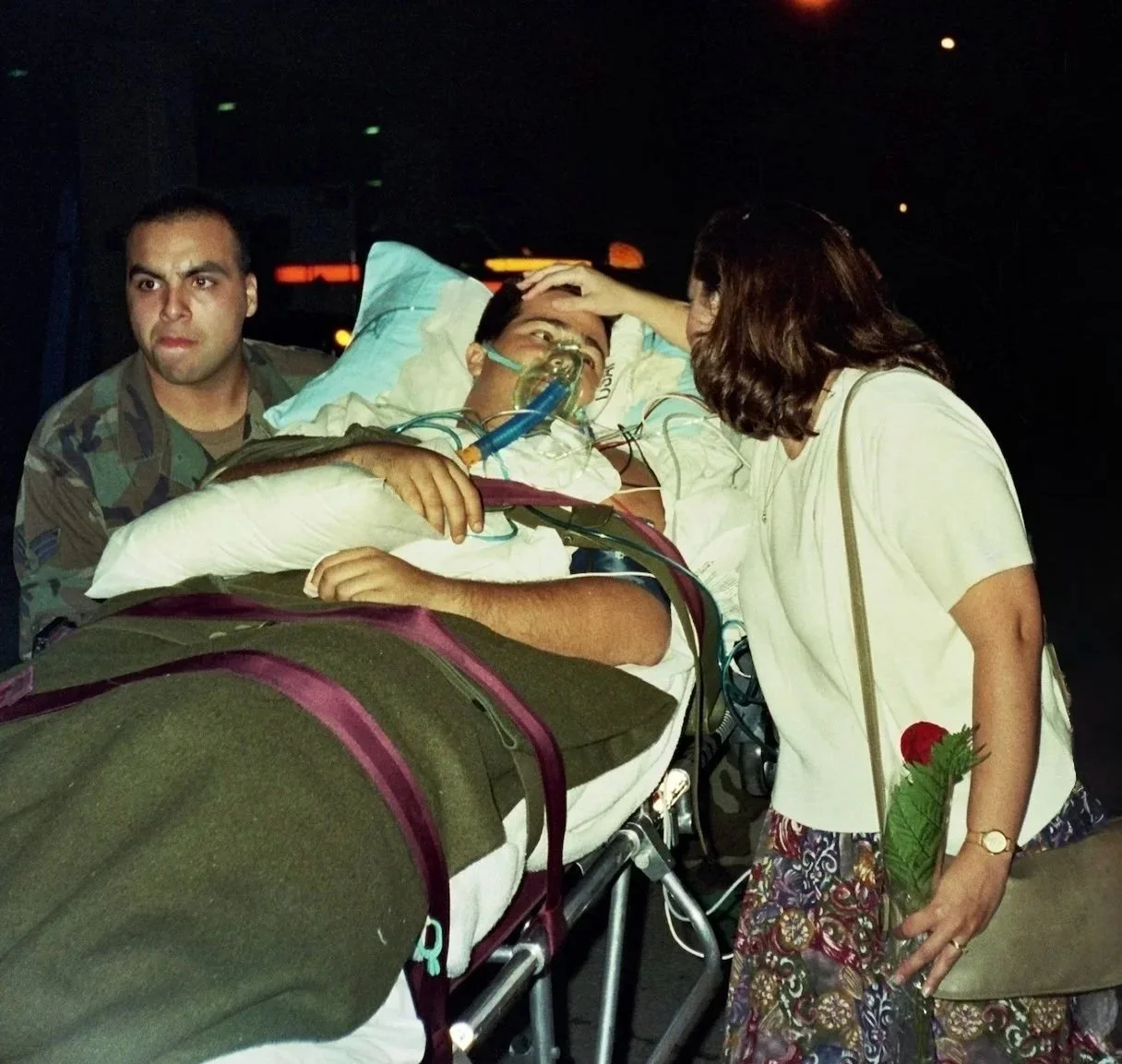 Special Ops pilot John Alvarez on a medical gurney reunited with his wife Shelley Alvarez after his dramatic rescue