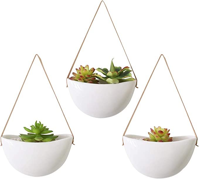 hanging white ceramic and leather wall planters.jpg