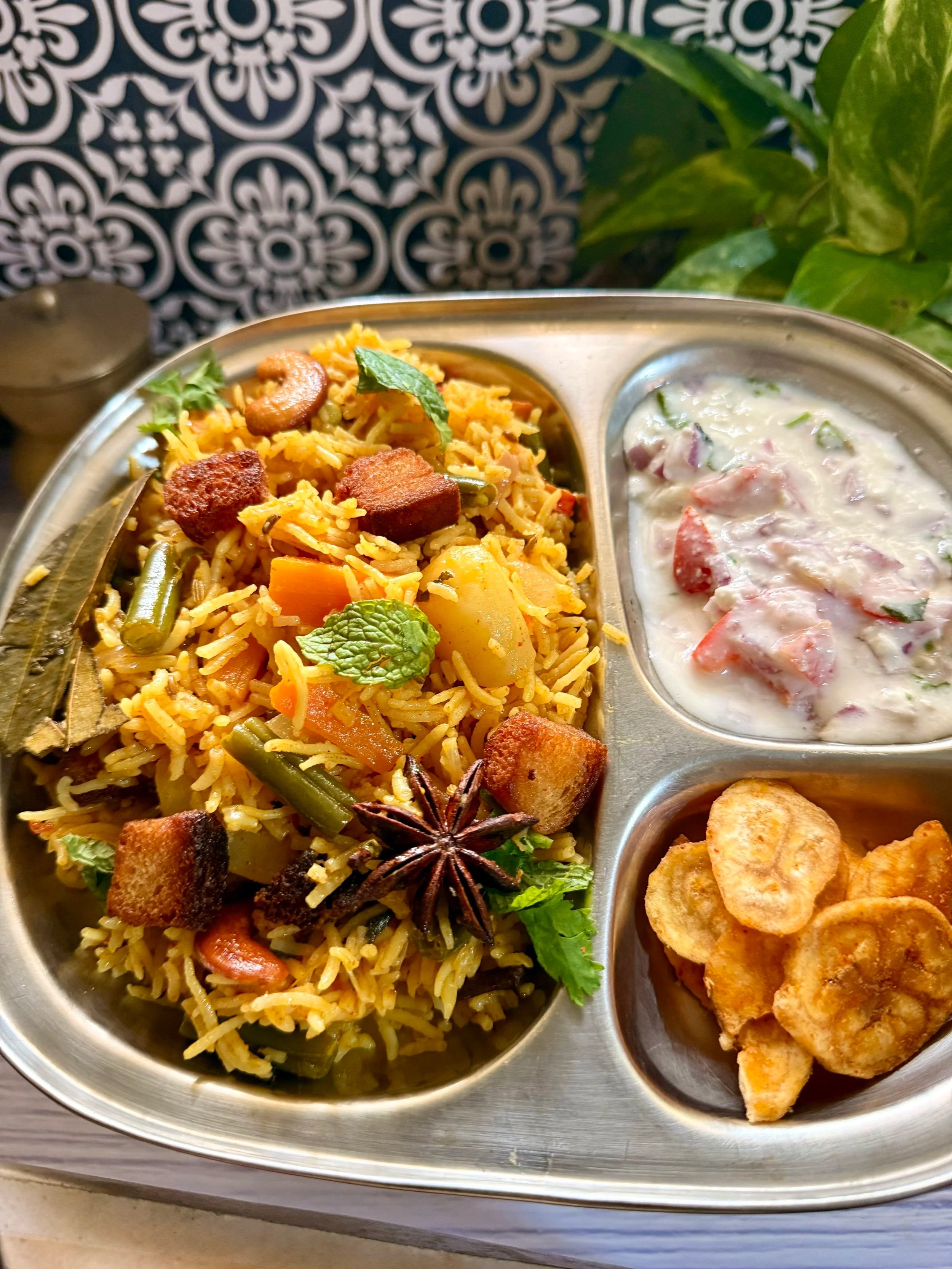 South Indian Brinji rice garnished with fried onions and mint in a steel pot