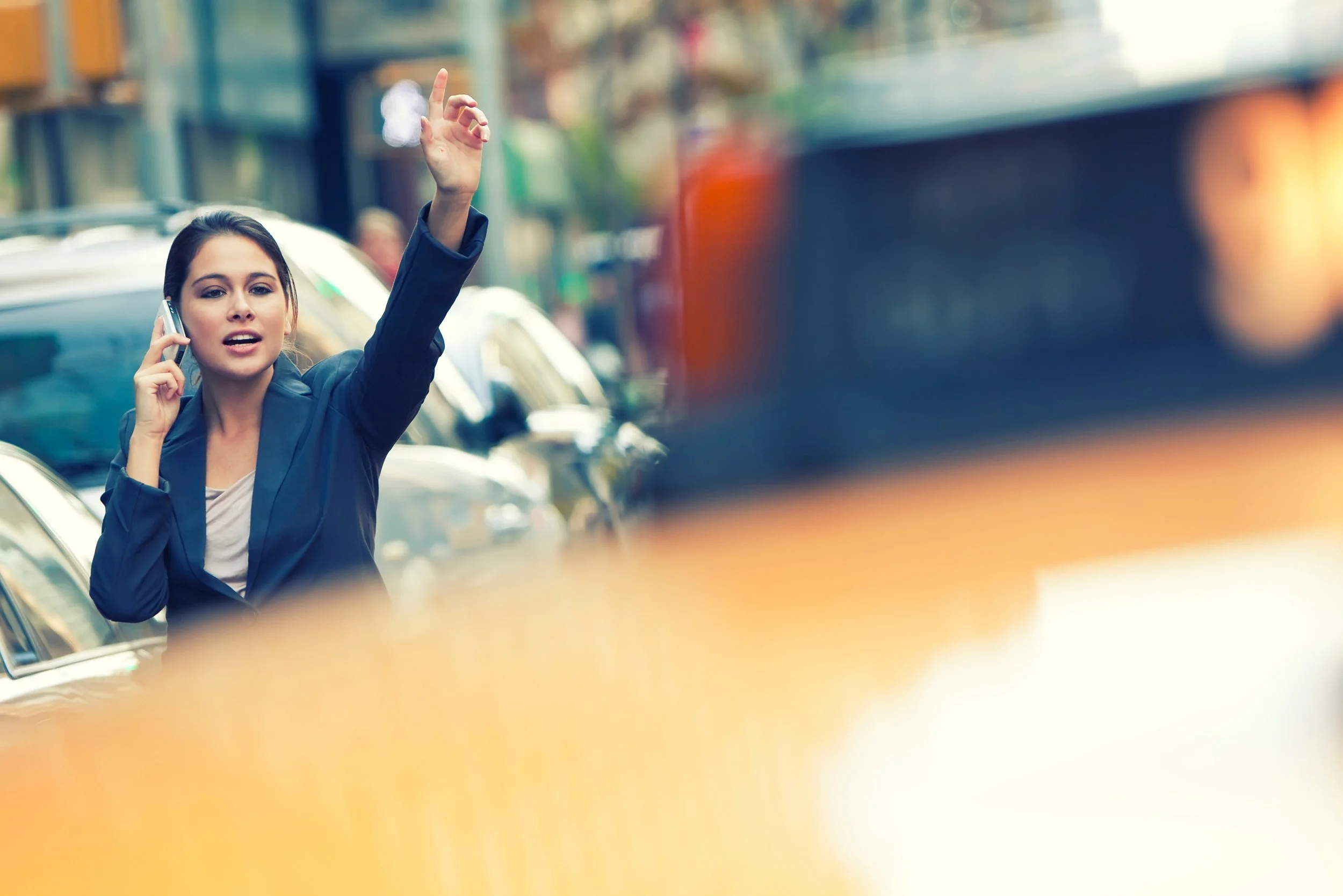 Woman Hailing NYC Taxi in Background.jpeg