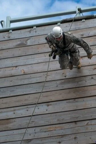 A U.S. soldier with the 7th Special Forces Group (Airborne), runs down a 40- foot rappelling wall at the training tower at Eglin Base Air Force Base, FL USA. PHOTO: SPC. STEVEN YOUNG, 2013, PUBLIC DOMAIN PHOTOGRAPH FROM DEFENSE IMAGERY MIL.