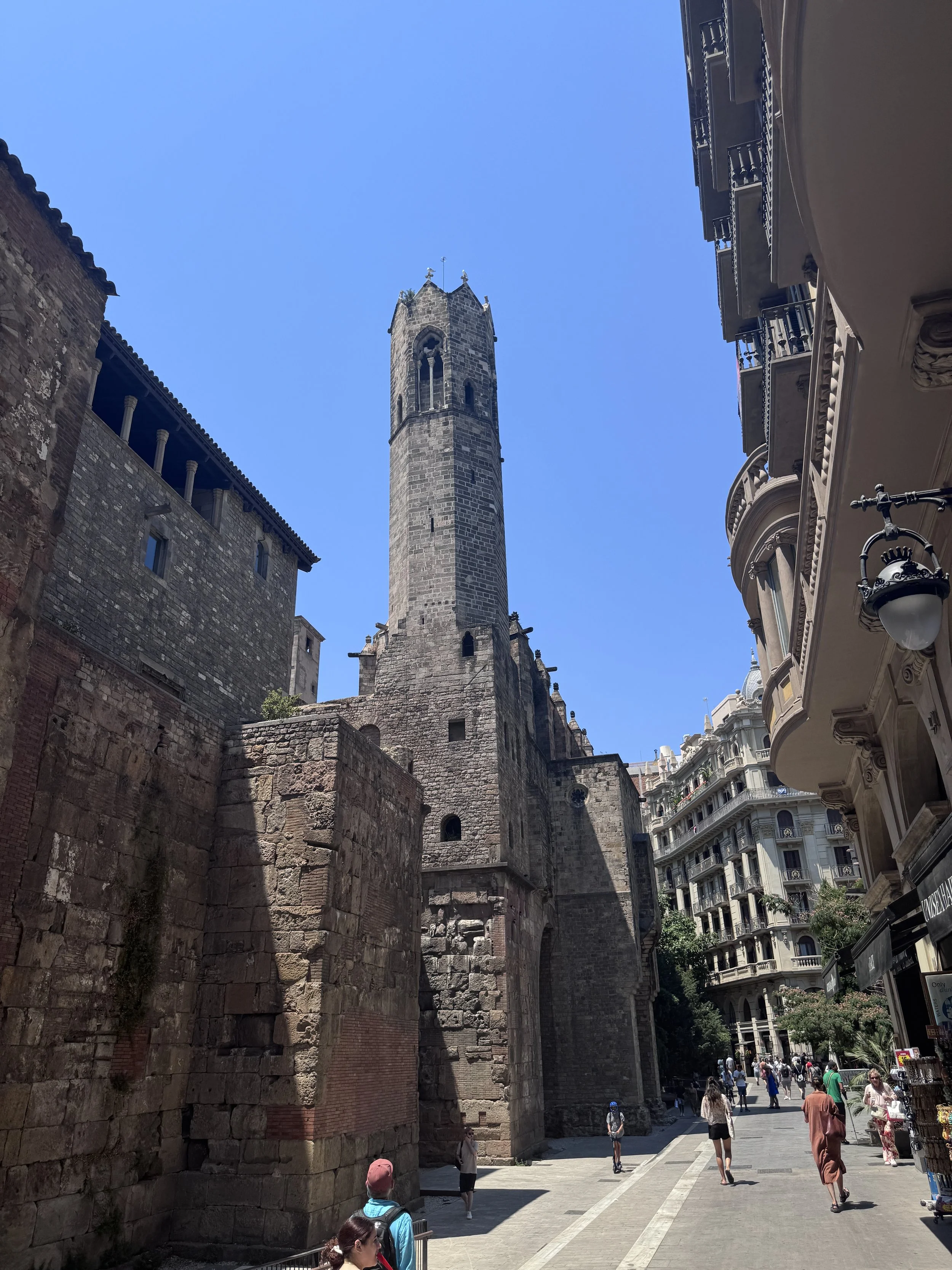Stone tower and historic streetscape in Barcelona, featured in Architectural Journeys.