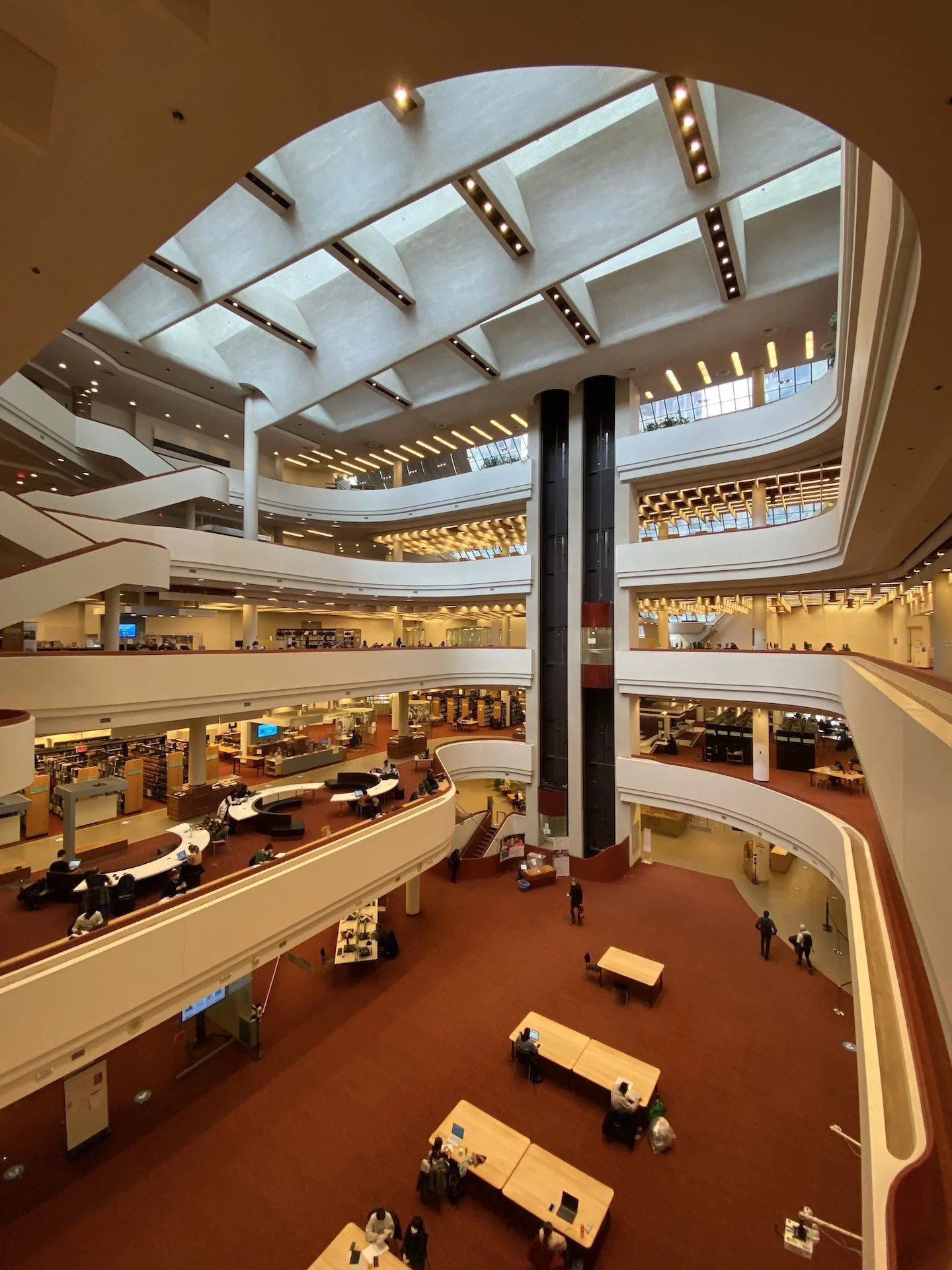 Curving reading levels surrounding the skylit atrium of Toronto Reference Library.