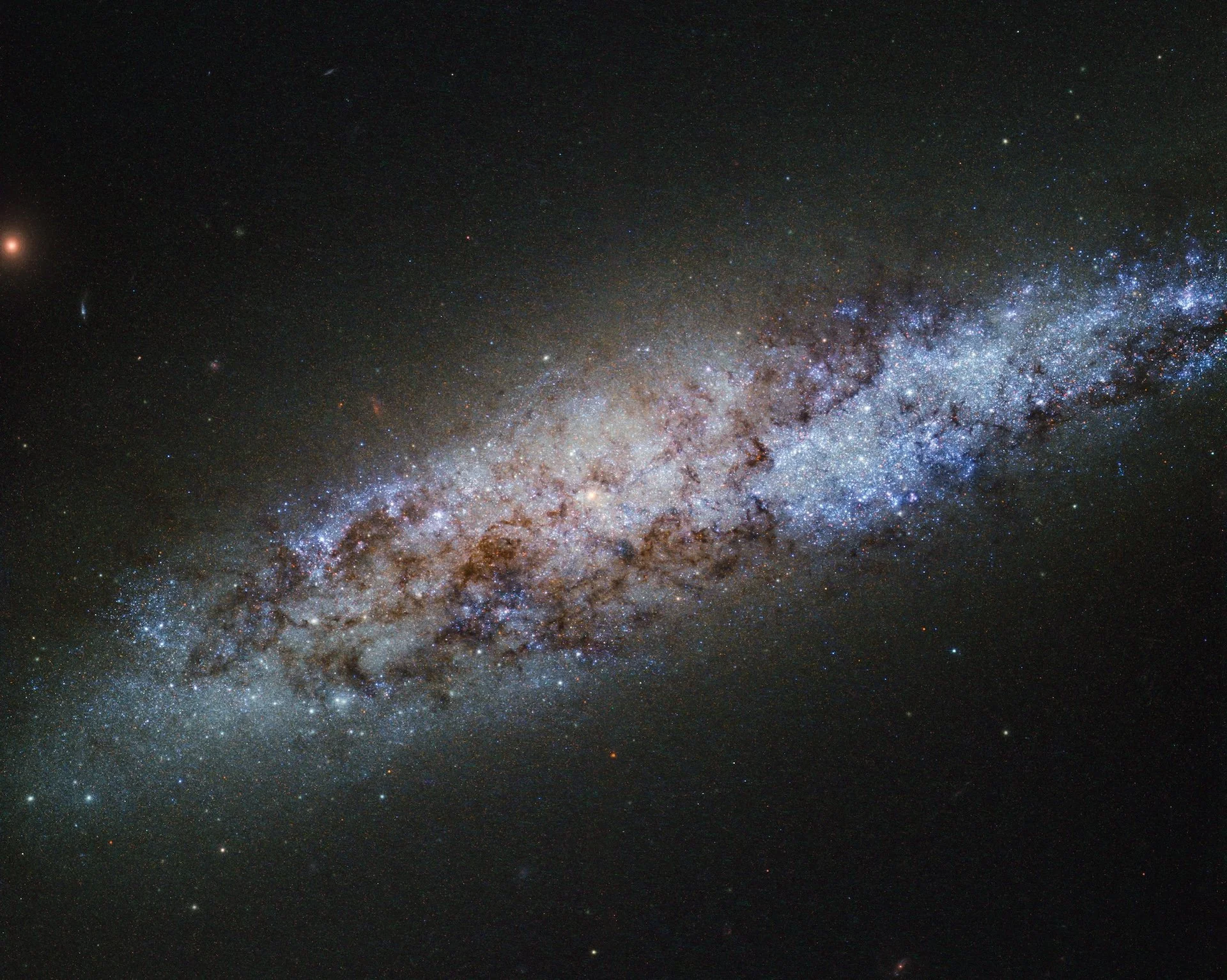 Dwarf spiral galaxy NGC 4605 photographed by the Hubble Space Telescope.
