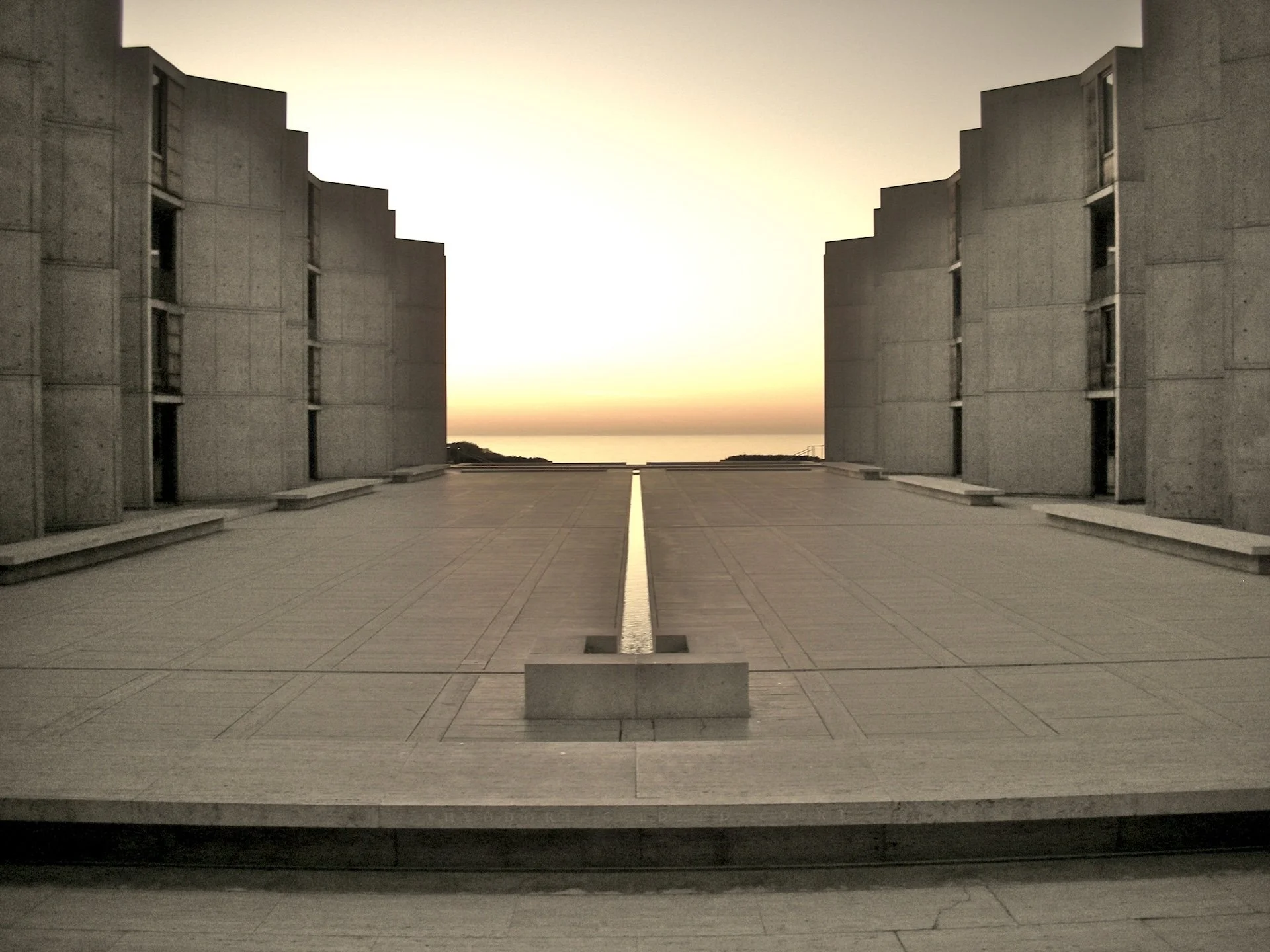 Symmetrical concrete buildings and a central water channel at Louis Kahn’s Salk Institute.