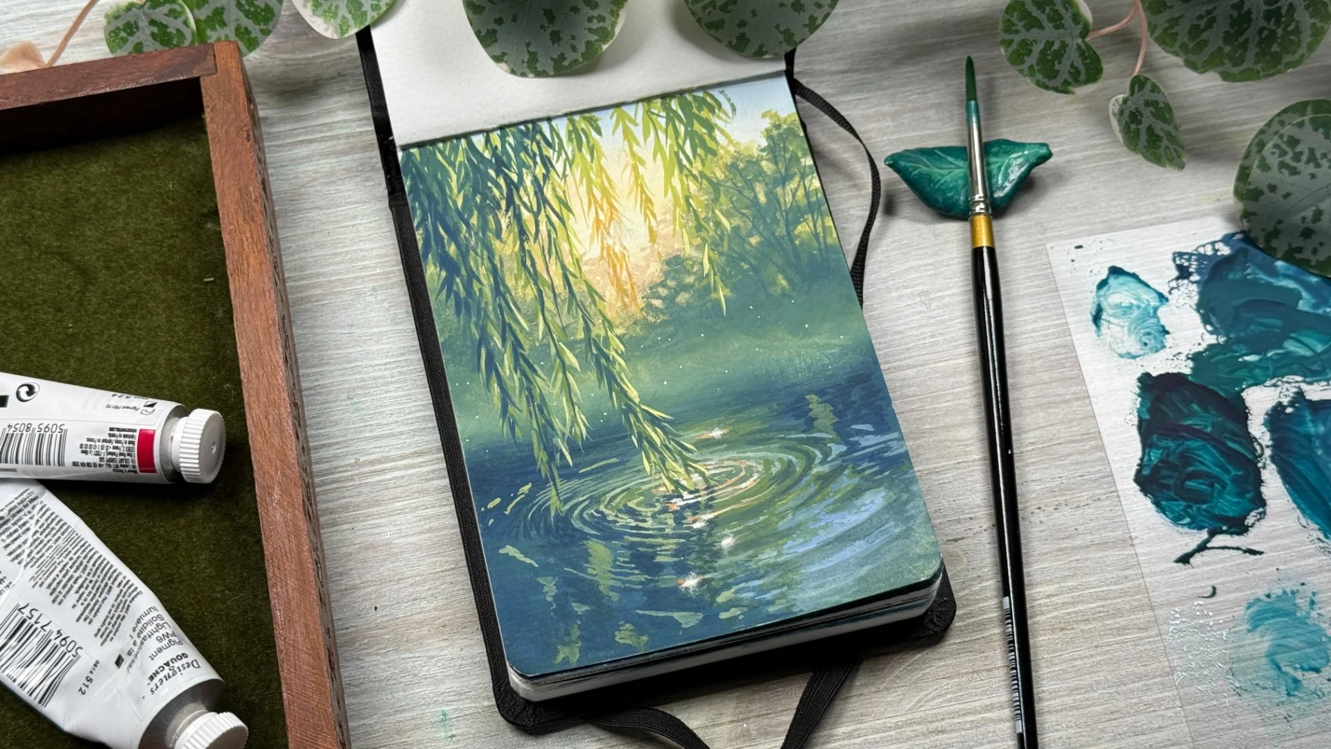 A gouache painting of a willow branch making ripples in the surface of a pond