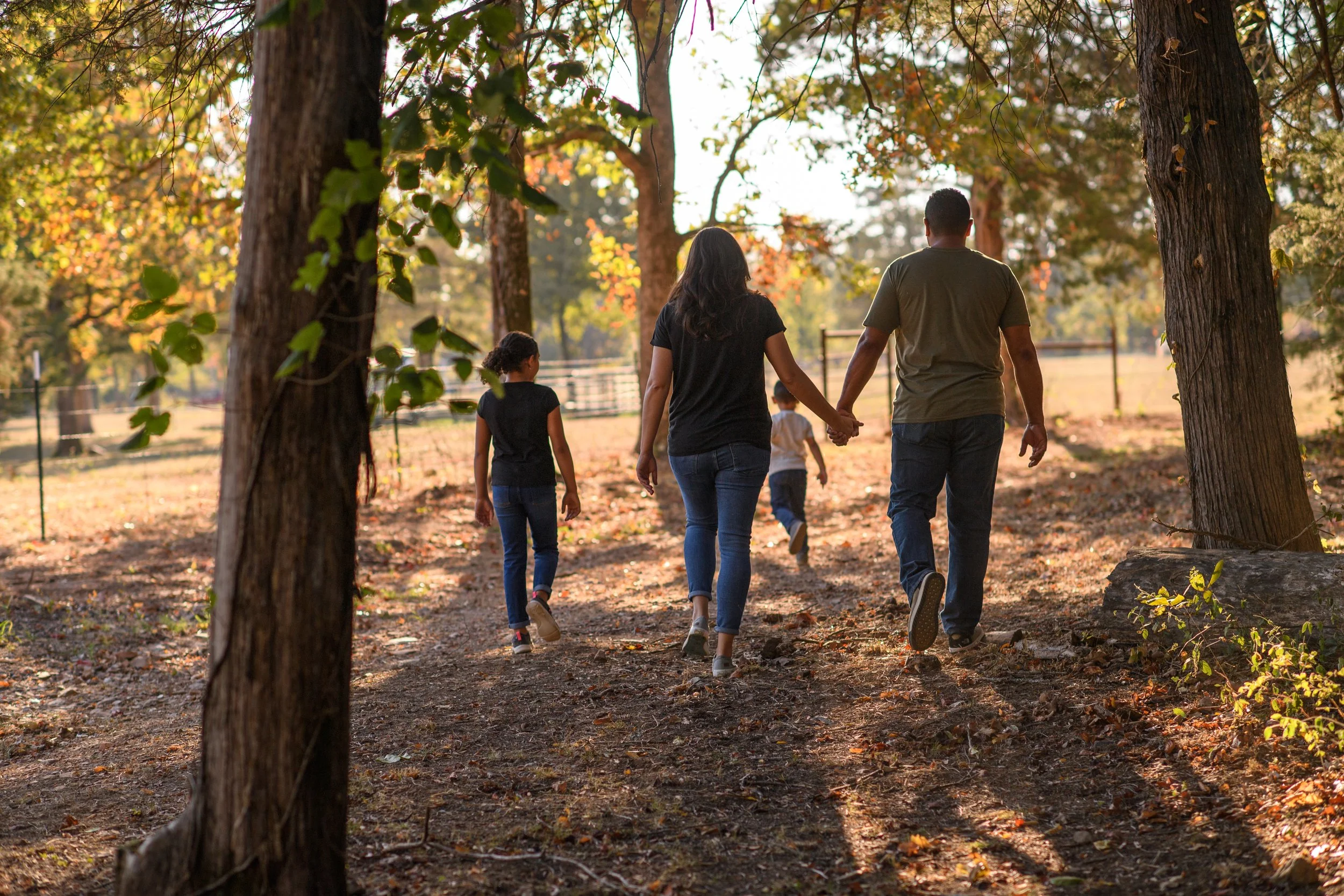 Family walking outdoors among trees at Timber Ridge Estates