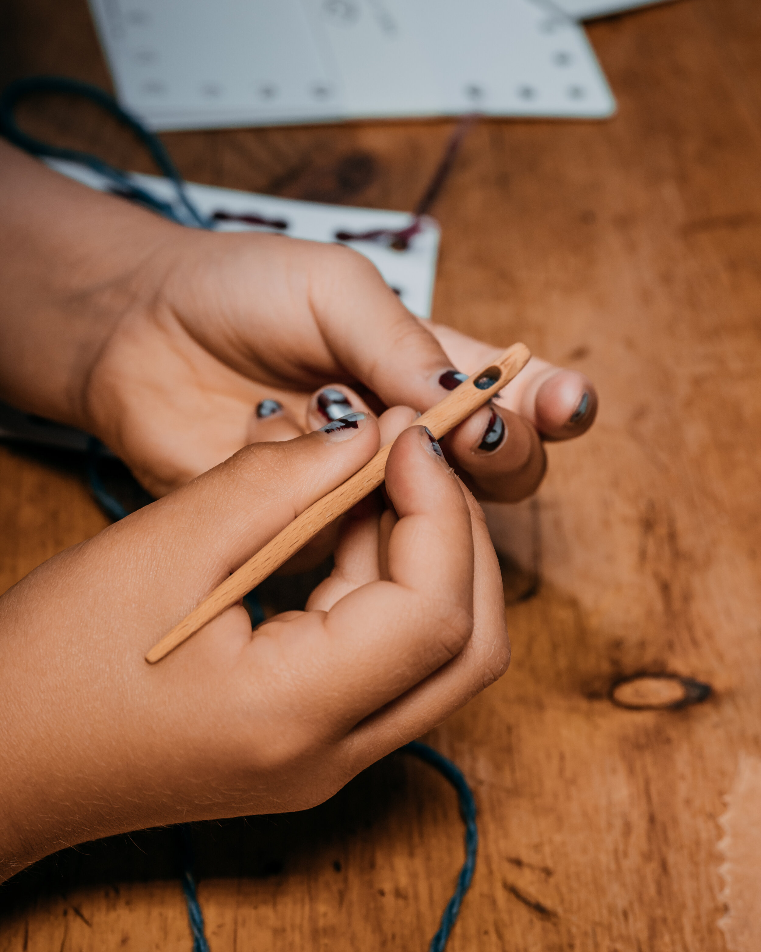 Threading needle wooden baground.jpeg