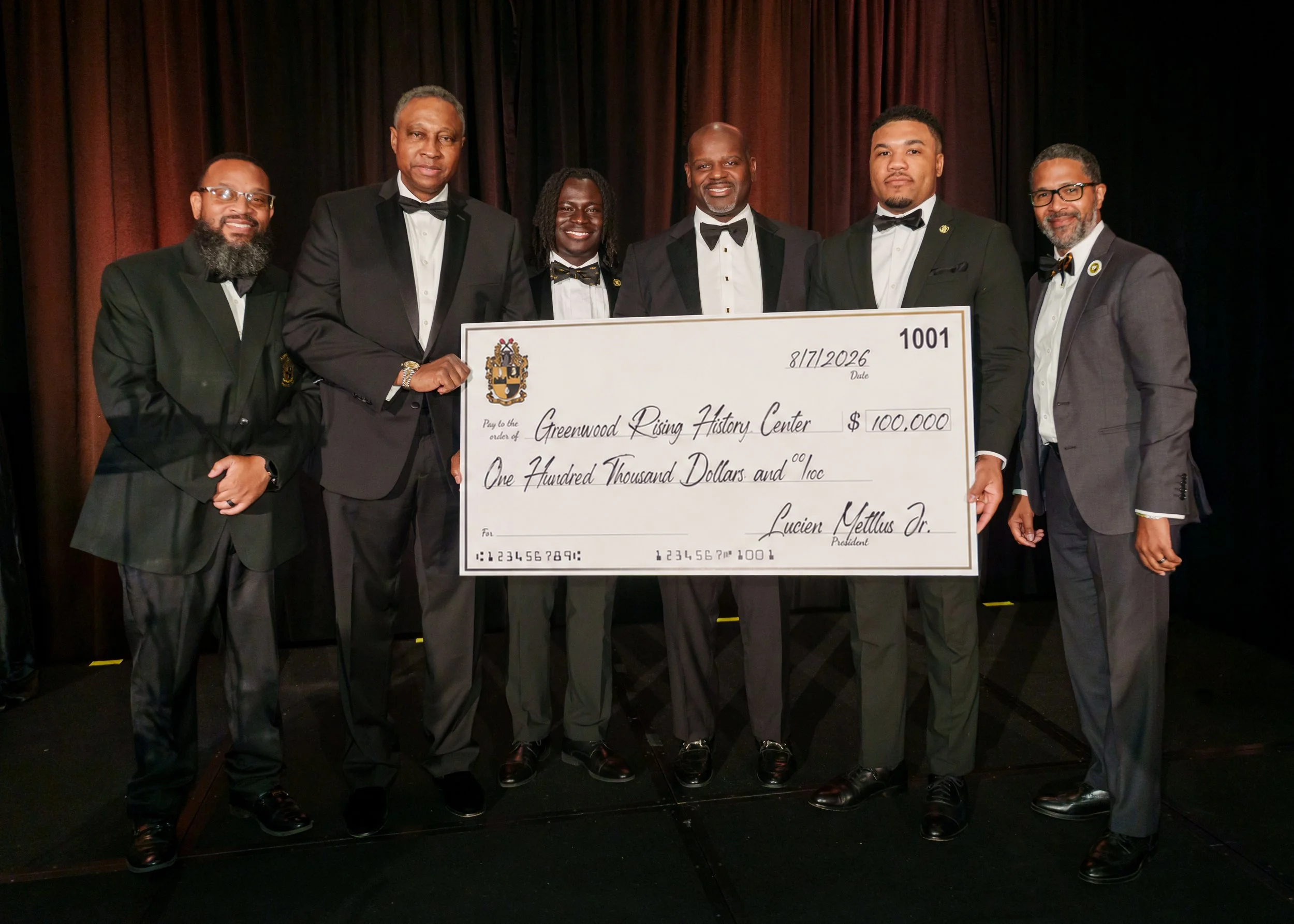 Alpha Phil Alpha Fraternity presentation of check_.jpg